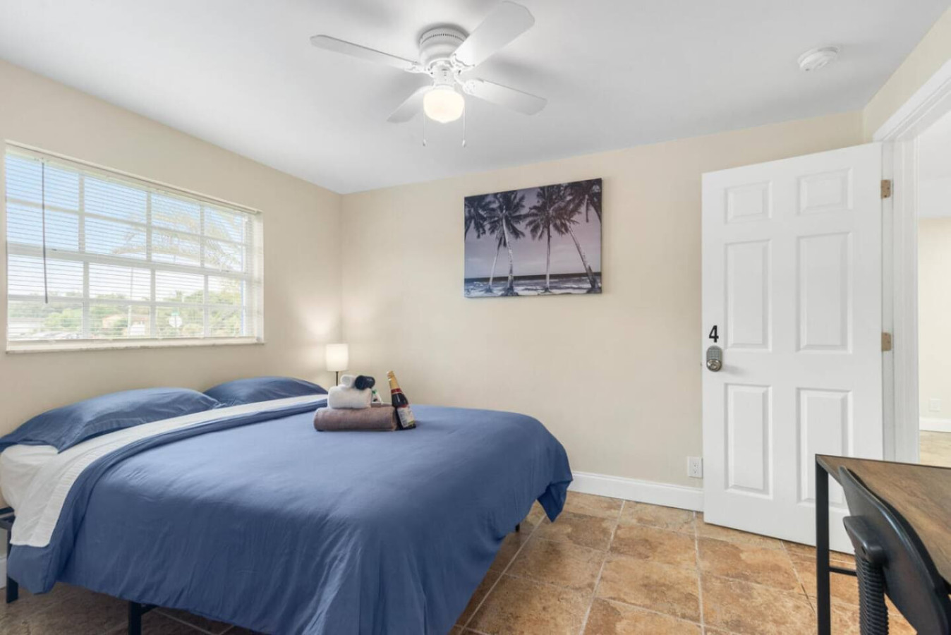 A comfortable queen-size bed with wall art above the headboard.