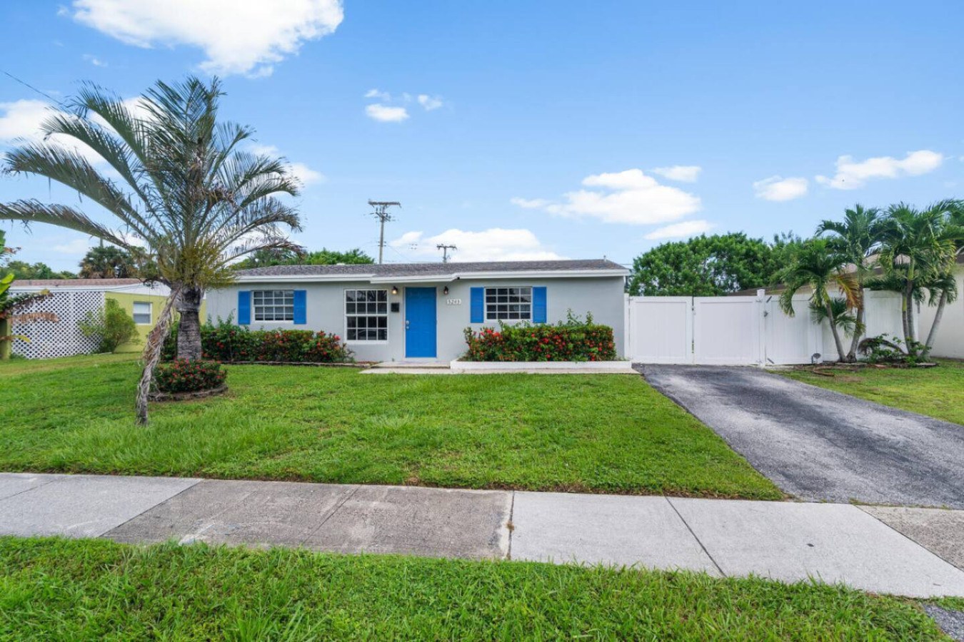 The front of the main house, freshly remodeled with the property's signature blue trim. It's the first thing your group sees pulling in.