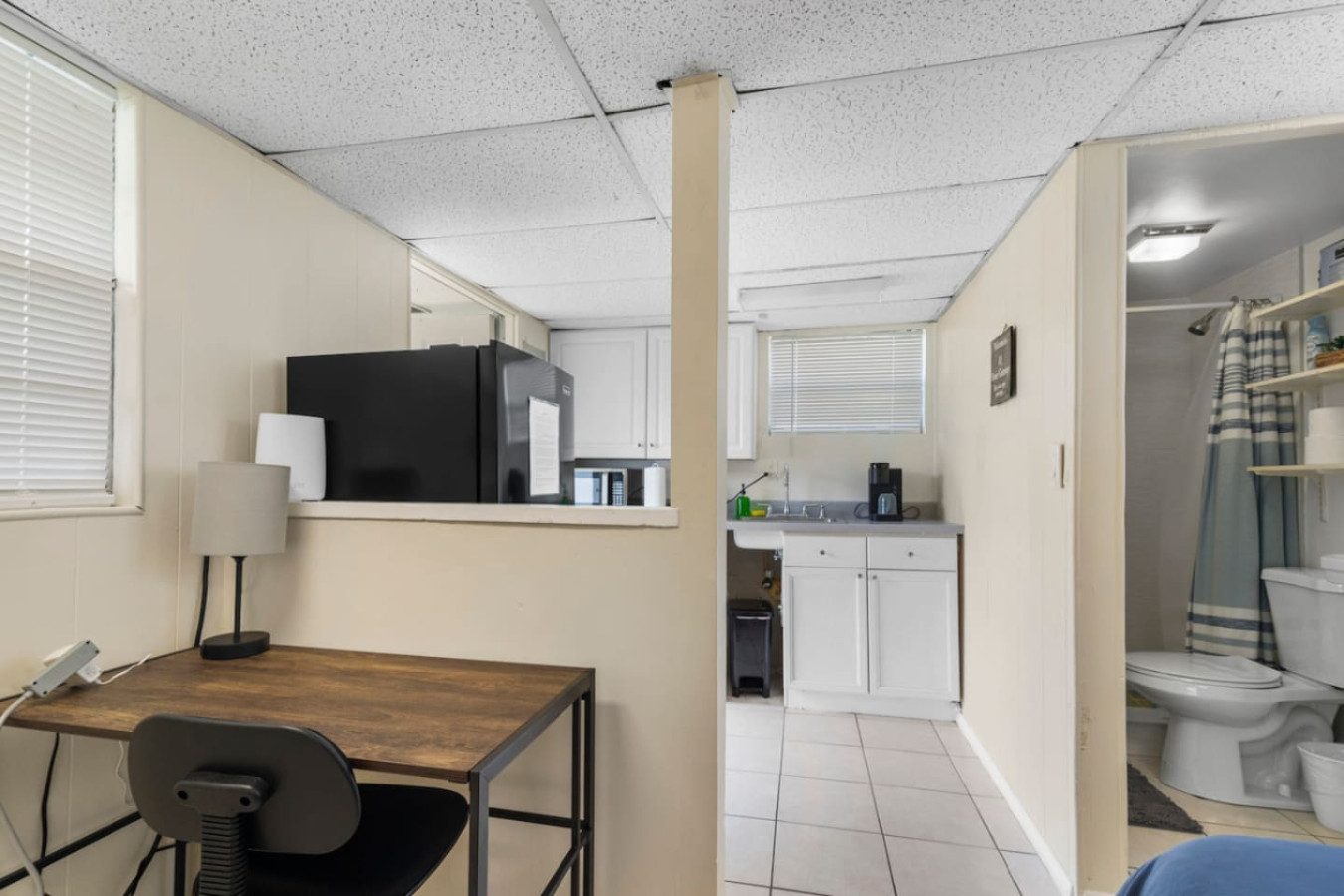 The guest house's main room, with a desk, kitchenette, and its own attached bathroom: a self-contained space for whoever books it.