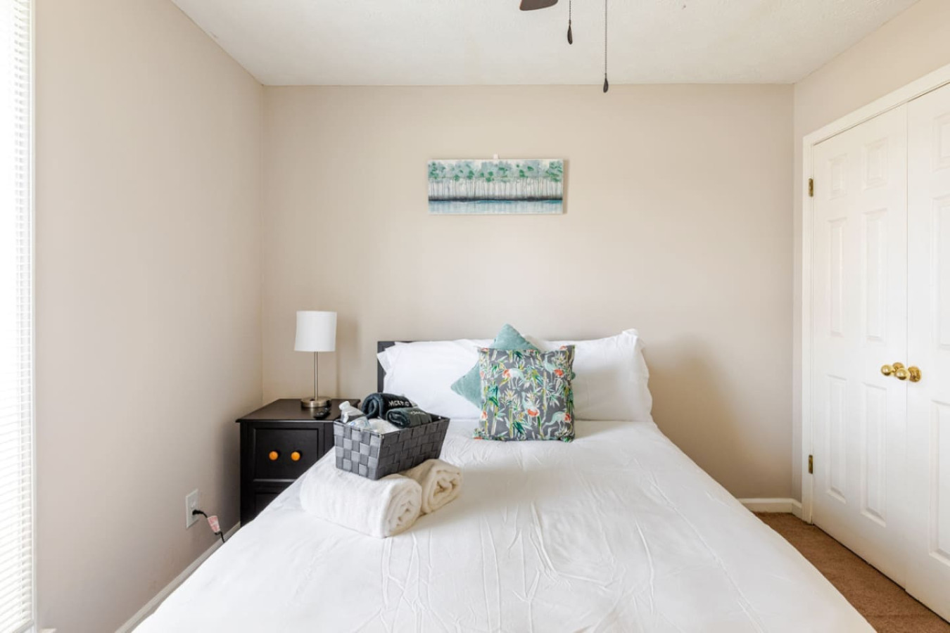 Bedroom 3 has a queen bed, a bedside lamp and a roomy closet, ready for another couple or a family member traveling with you.
