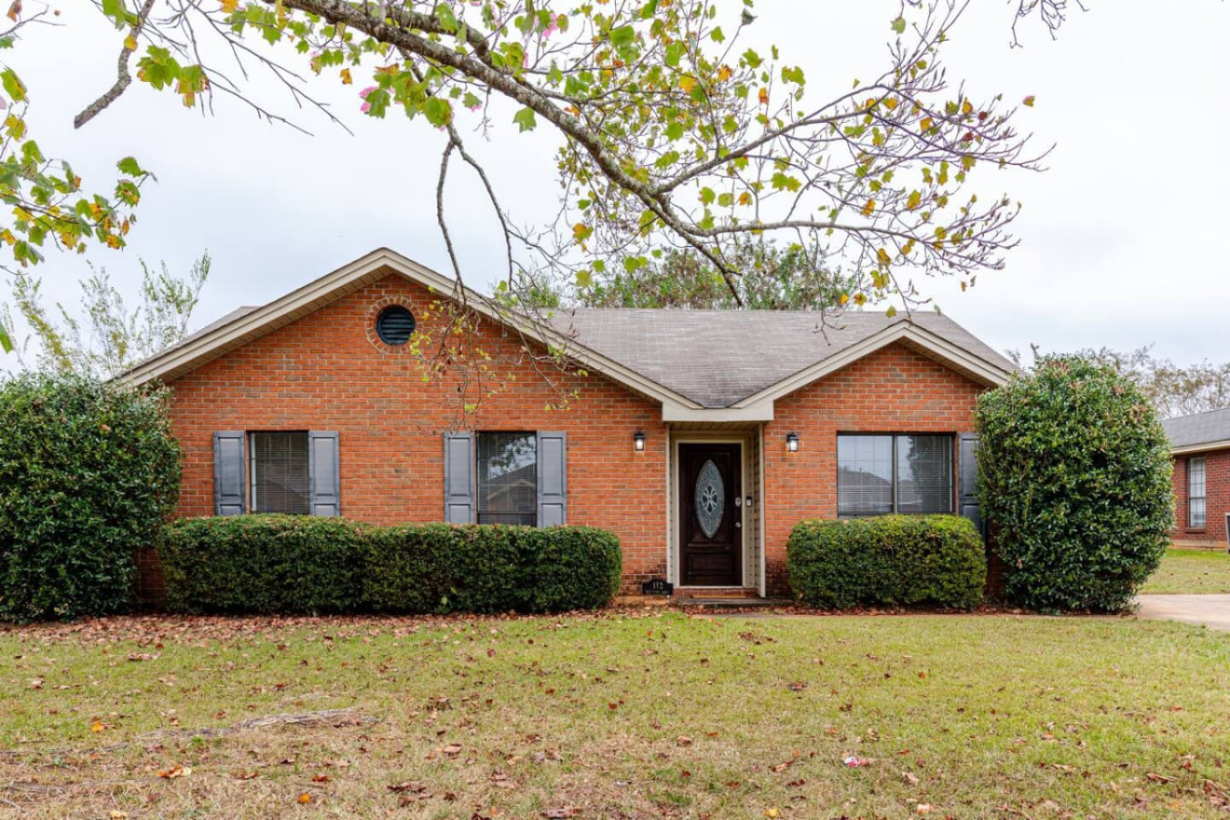 Whispering Oaks is a single-story brick home on Montgomery's east side, with a wide front lawn and free parking on site.
