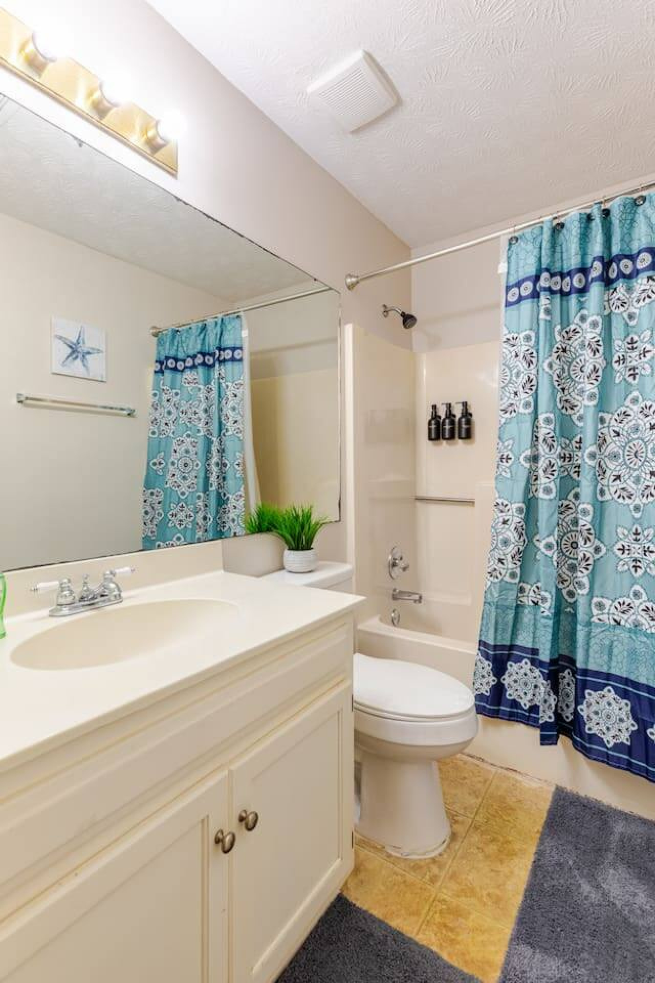 The shared bathroom includes a full vanity alongside the tub and shower.