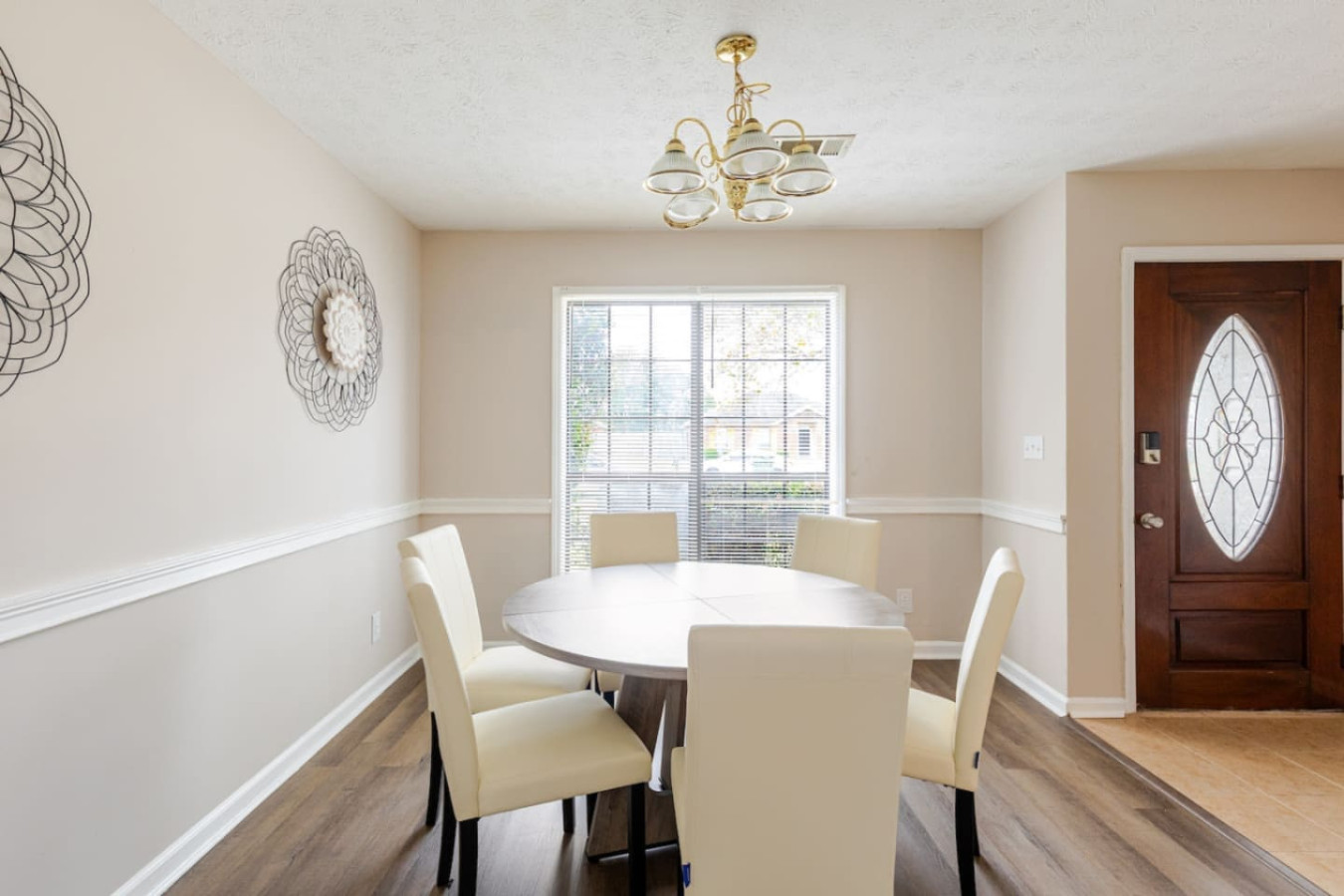 The dining table sits just inside the front door, set for breakfast before a busy day or a home-cooked dinner after one.