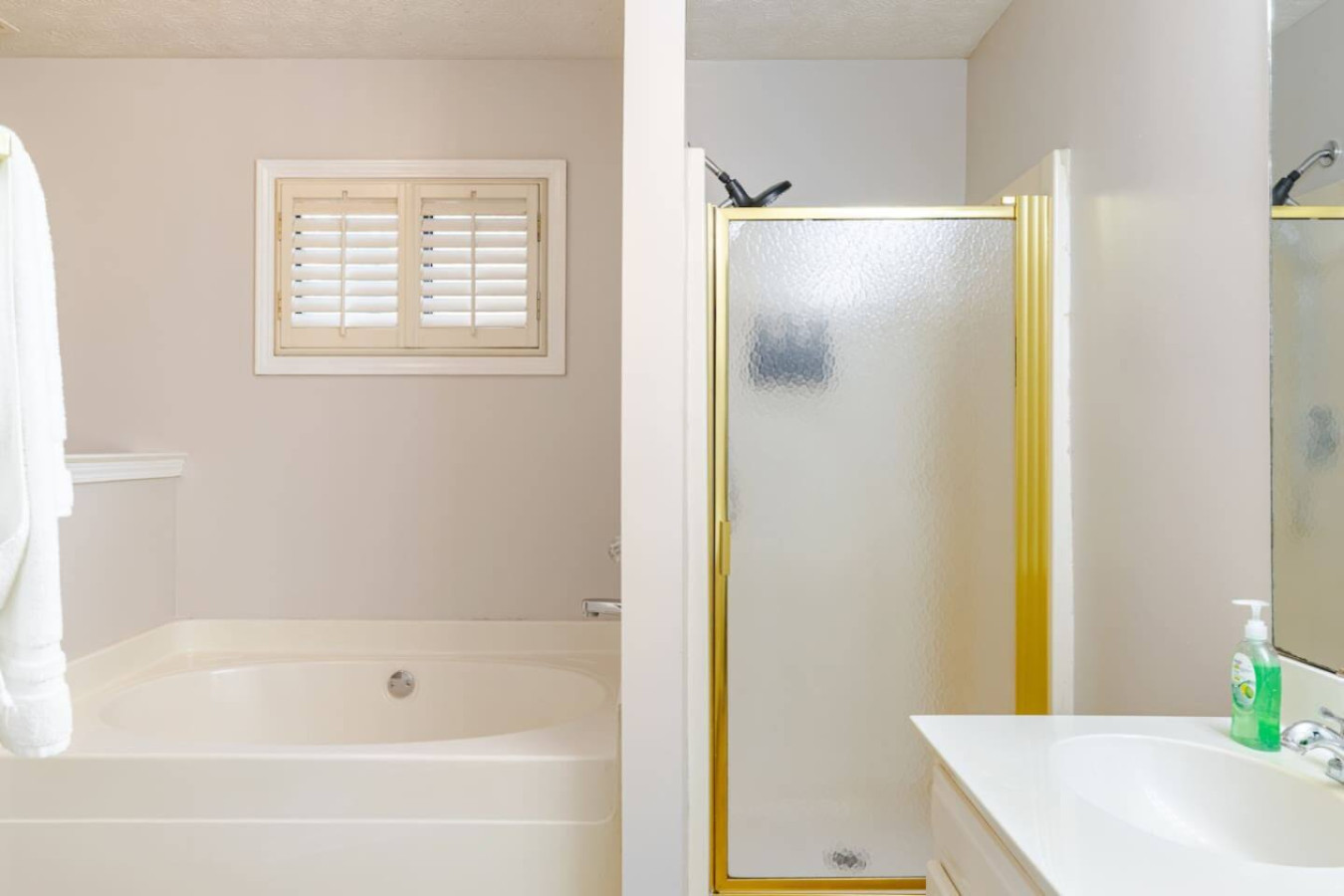 The private bathroom has a soaking tub for a long soak and a separate glass shower for a quick one.