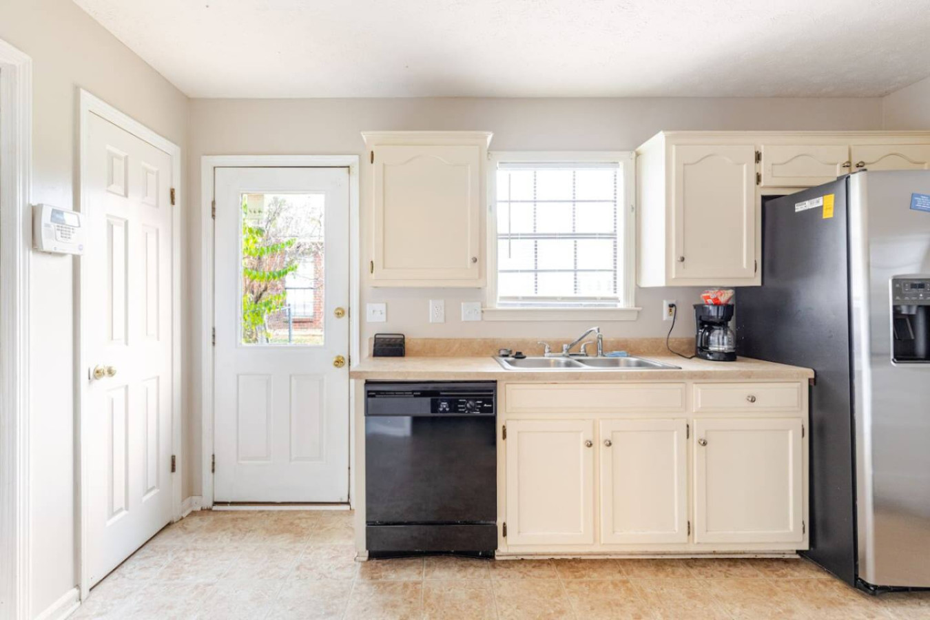 A dishwasher speeds up cleanup, and the back door leads straight out to the yard.