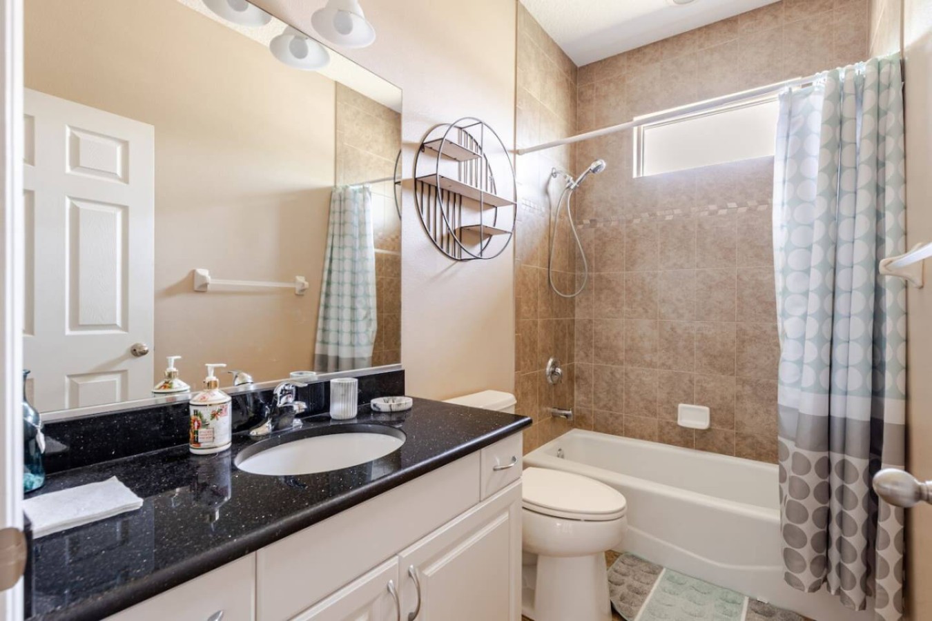 Double vanity, tub, and separate shower. This bathroom does double duty for a fuller wing of the house.