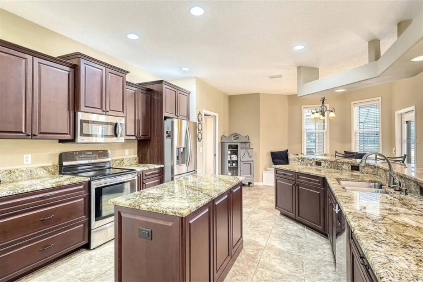 Cherry cabinets and an oversized island, the heart of the house for a group that plans to cook its own meals, not order in.