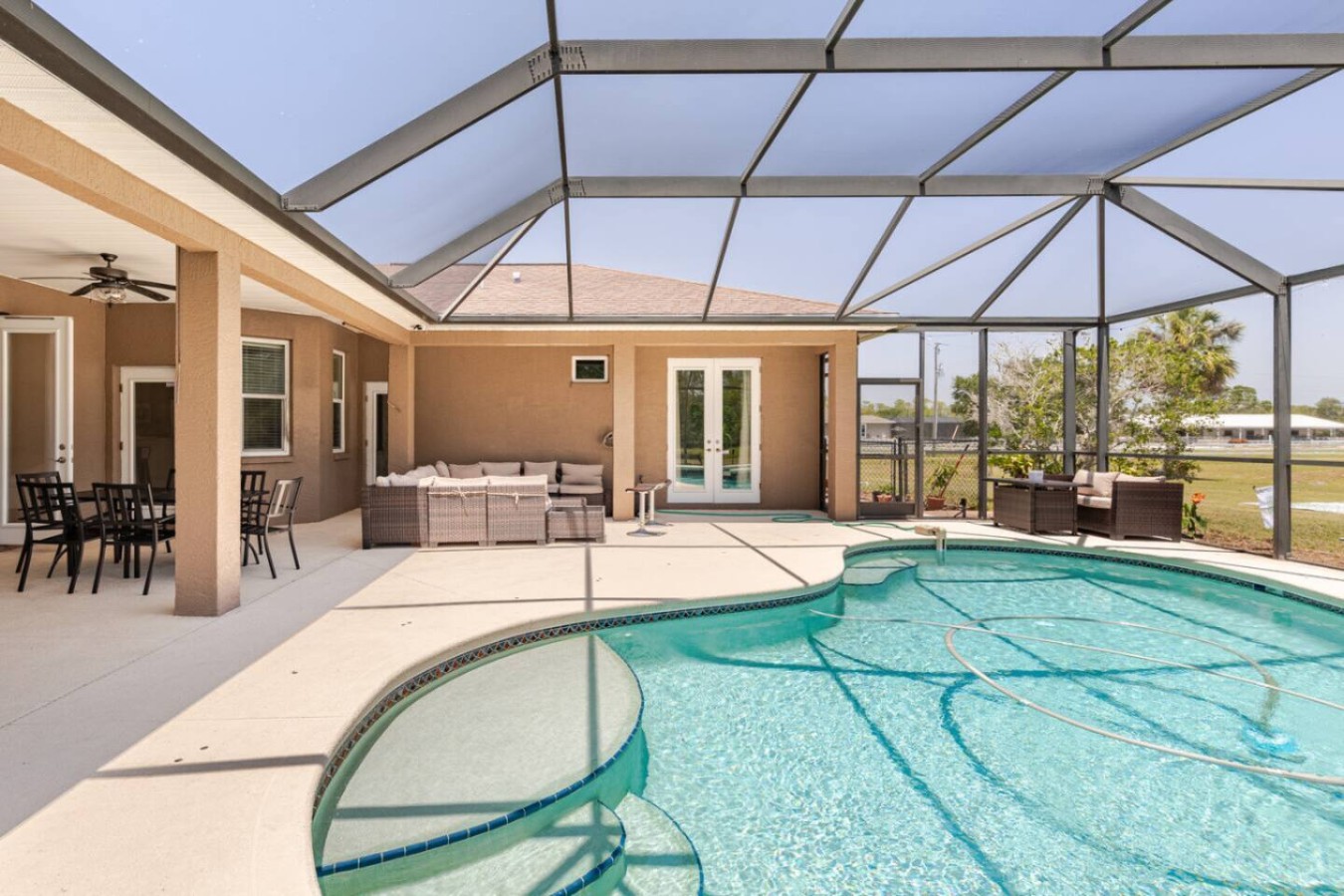 Pool deck with room to really spread out towels, chairs, and a crowd larger than most rentals can handle.