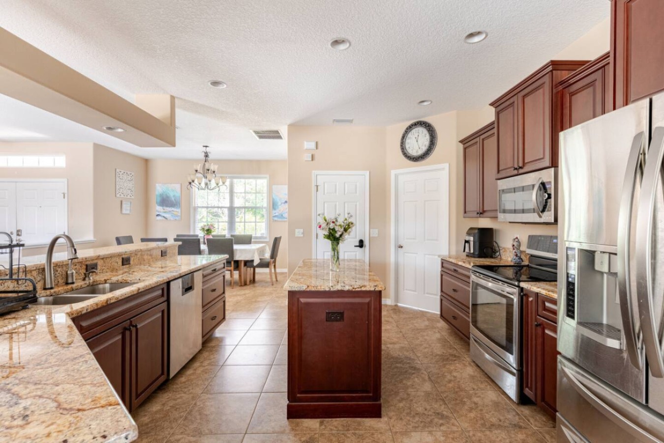 Dark cabinetry runs the length of the kitchen, built for a household this size to cook together.