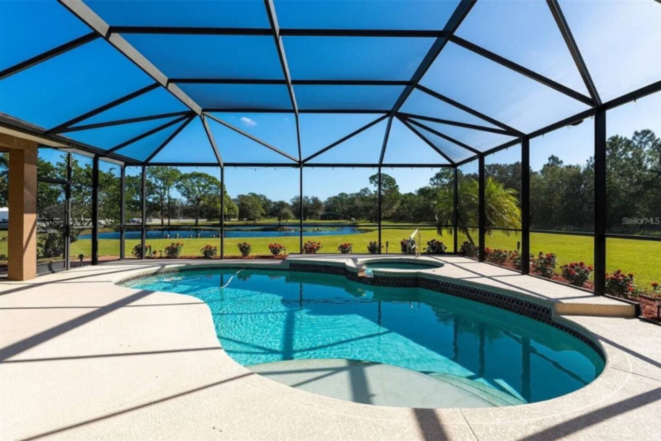 From the pool, the pond is close enough to see through the screen, two water features on one property.