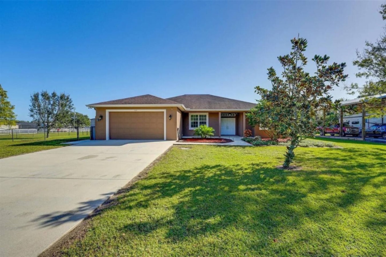 The driveway carries you past the noise, trees closing in until the property opens up ahead.