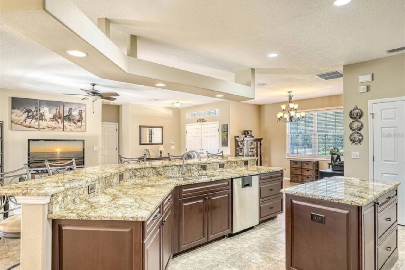 Vaulted, beamed ceilings carry from the kitchen straight into the great room, the kind of scale that makes a full house feel roomy instead of crowded.