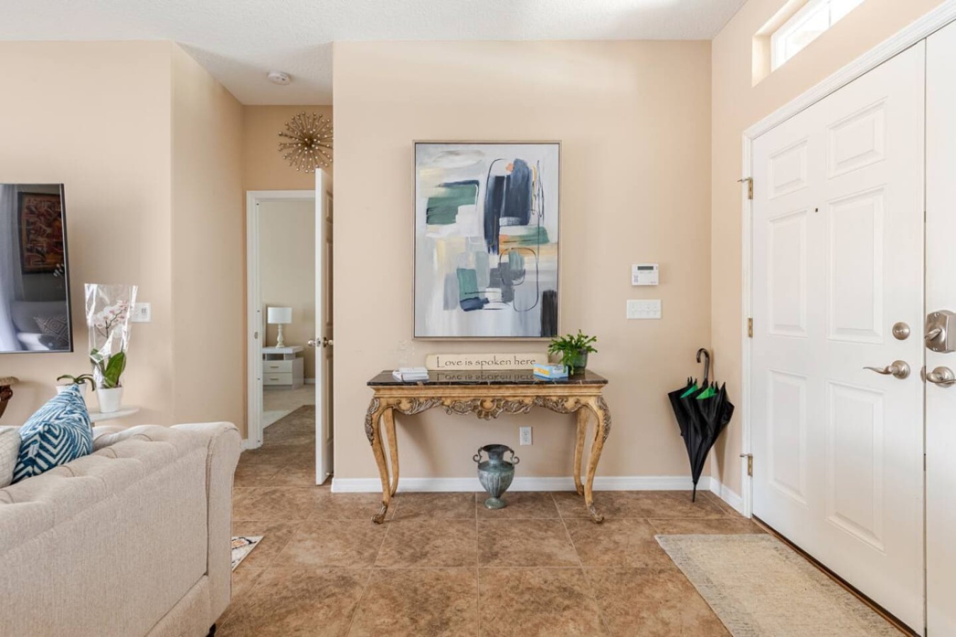 Living room opens straight into the entry hallway, no wasted square footage between the front door and the couch.