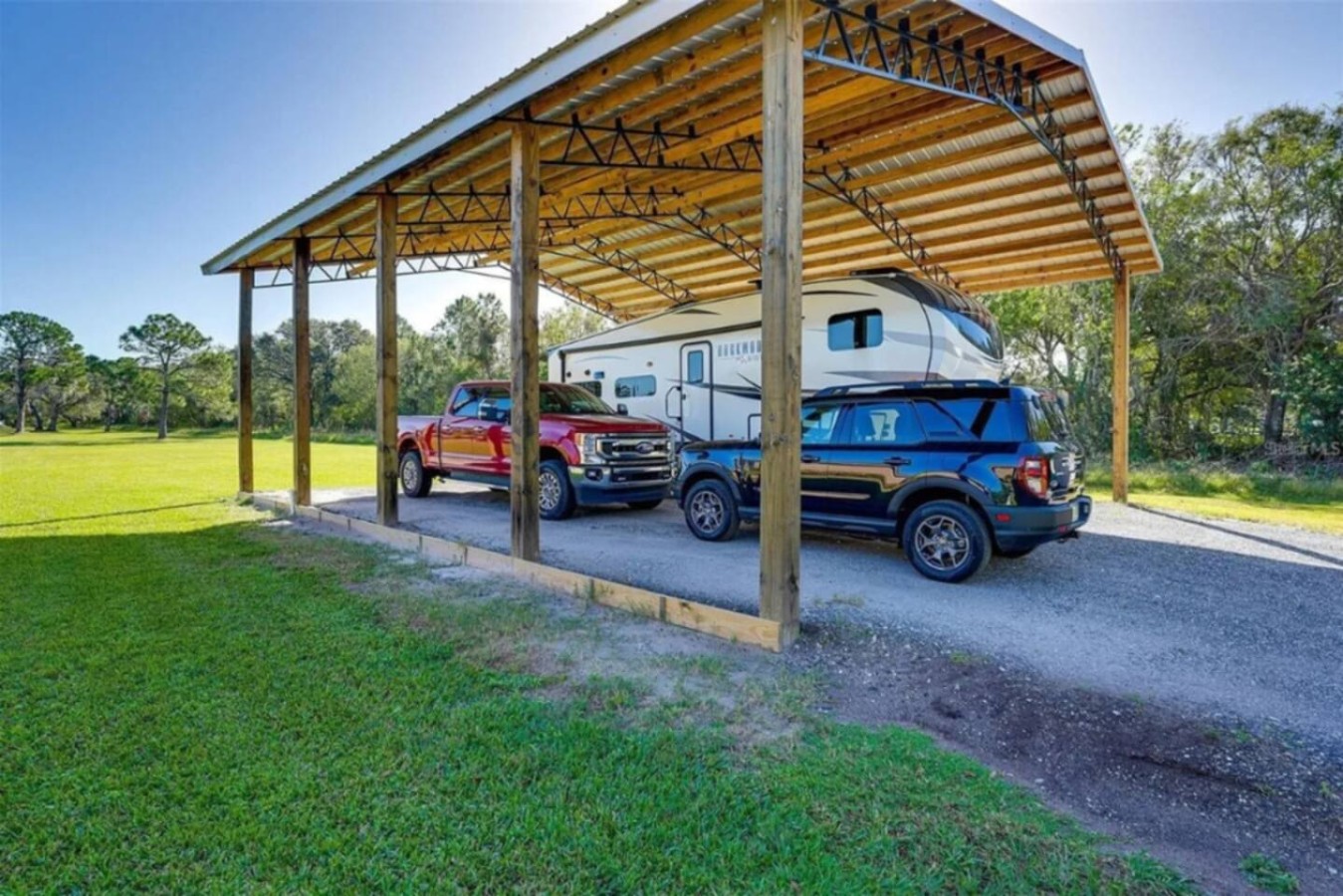 The same carport in use, enough coverage for the vehicles a large group brings.