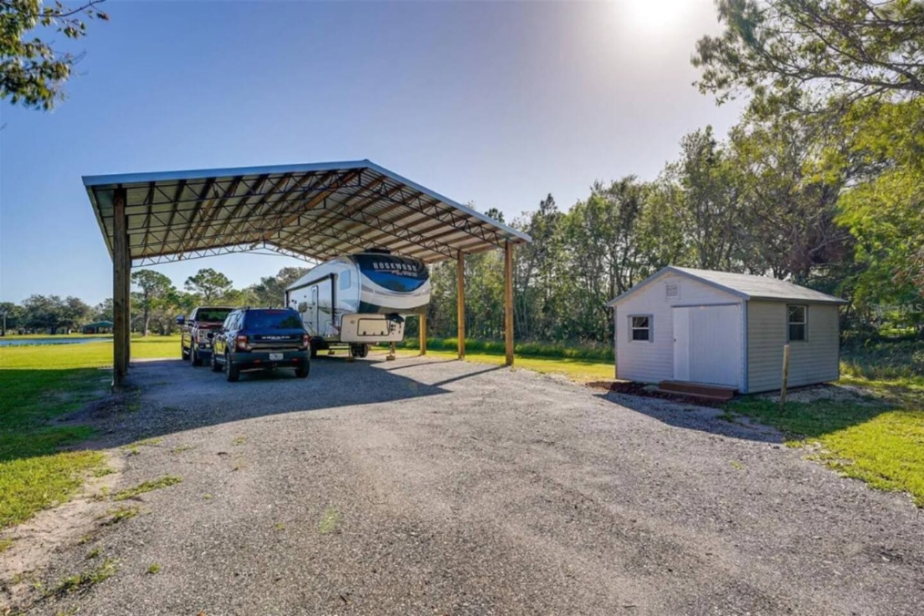 RV carport and storage shed, practical infrastructure on a working nine-acre property.