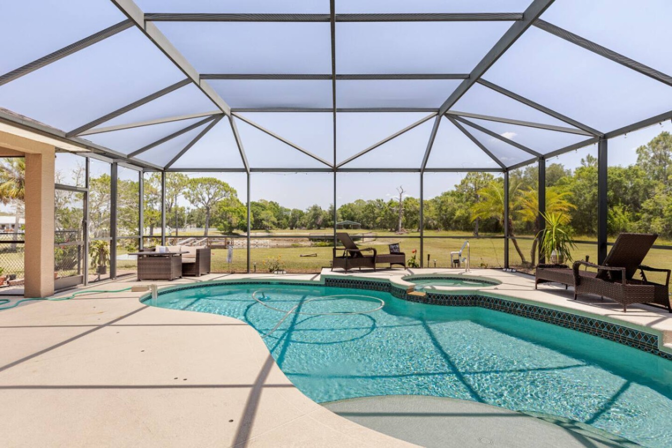 The screened pool itself, kept private and bug-free behind the enclosure.