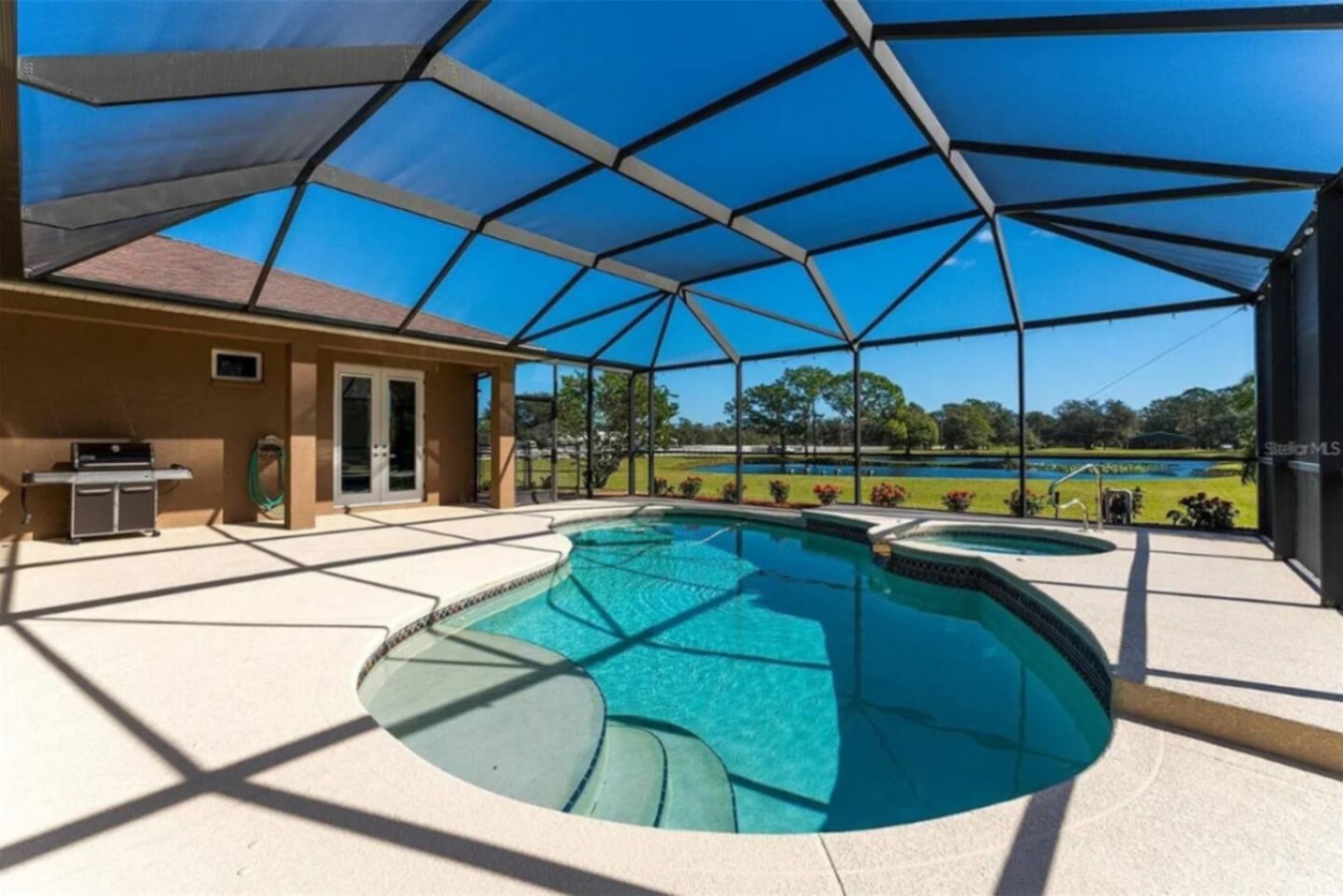A grill sits right at the pool's edge, no need to leave the water to start dinner.