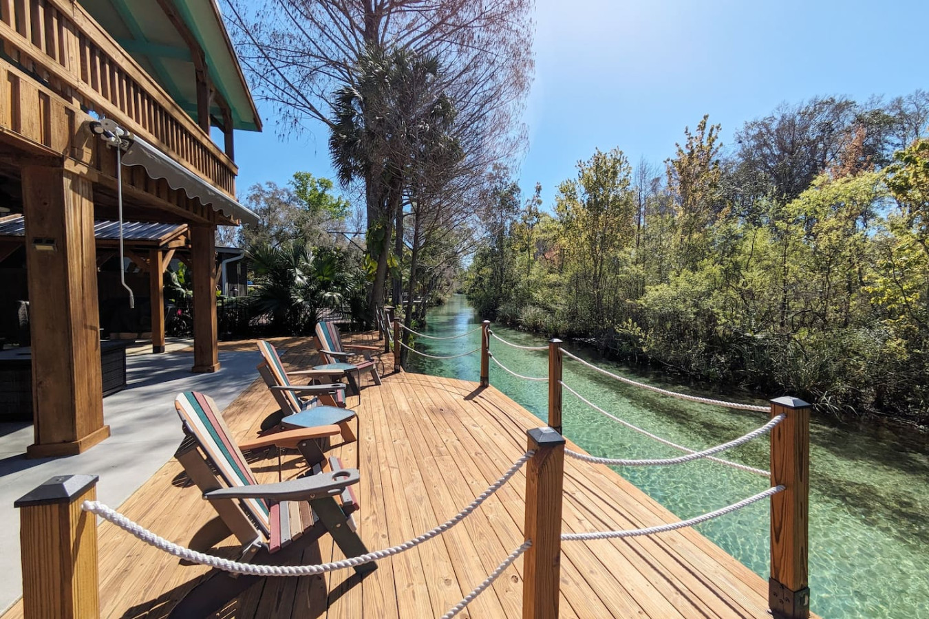 Adirondack chairs along the riverside deck