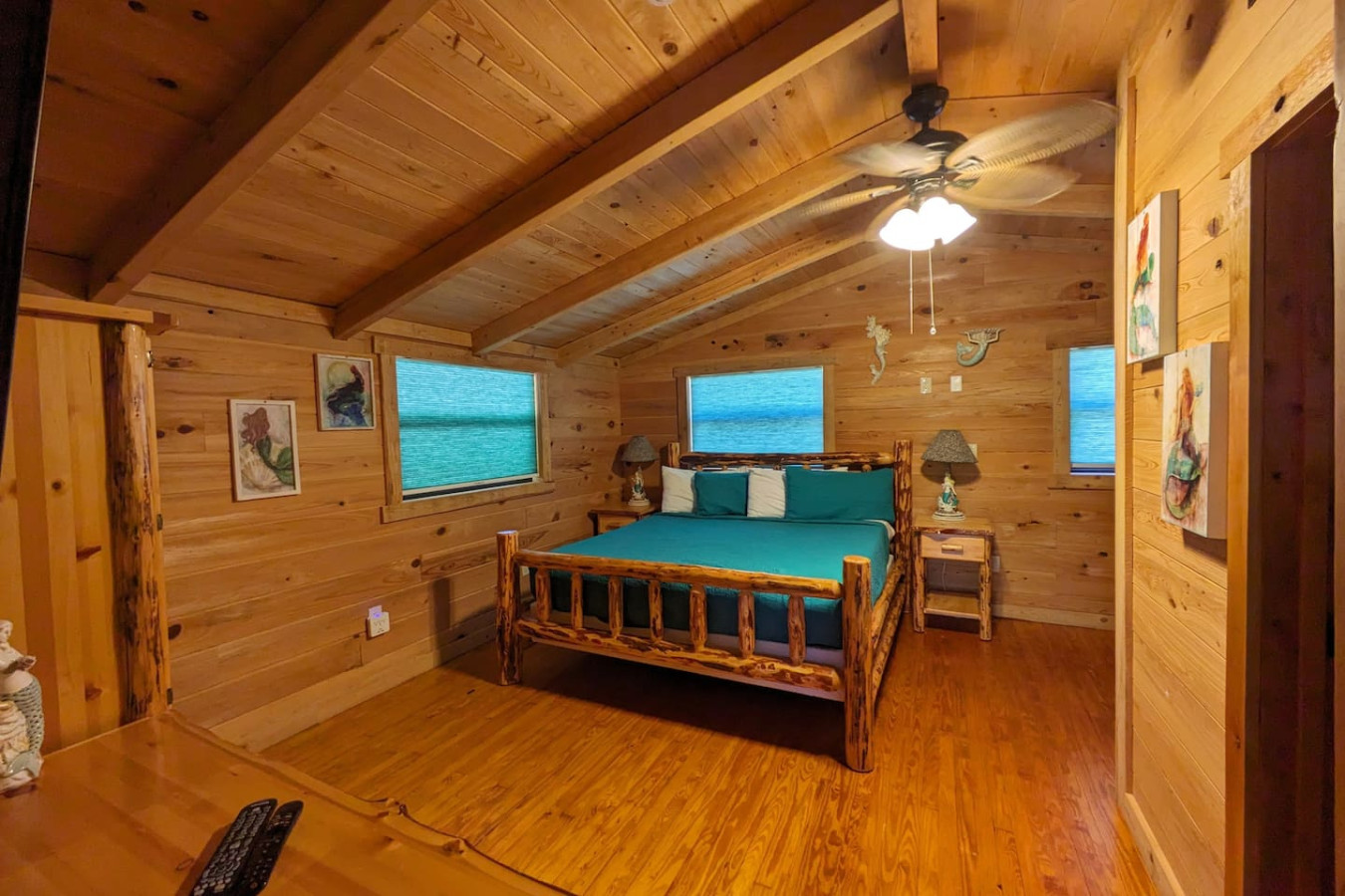 King bed under a vaulted cedar ceiling
