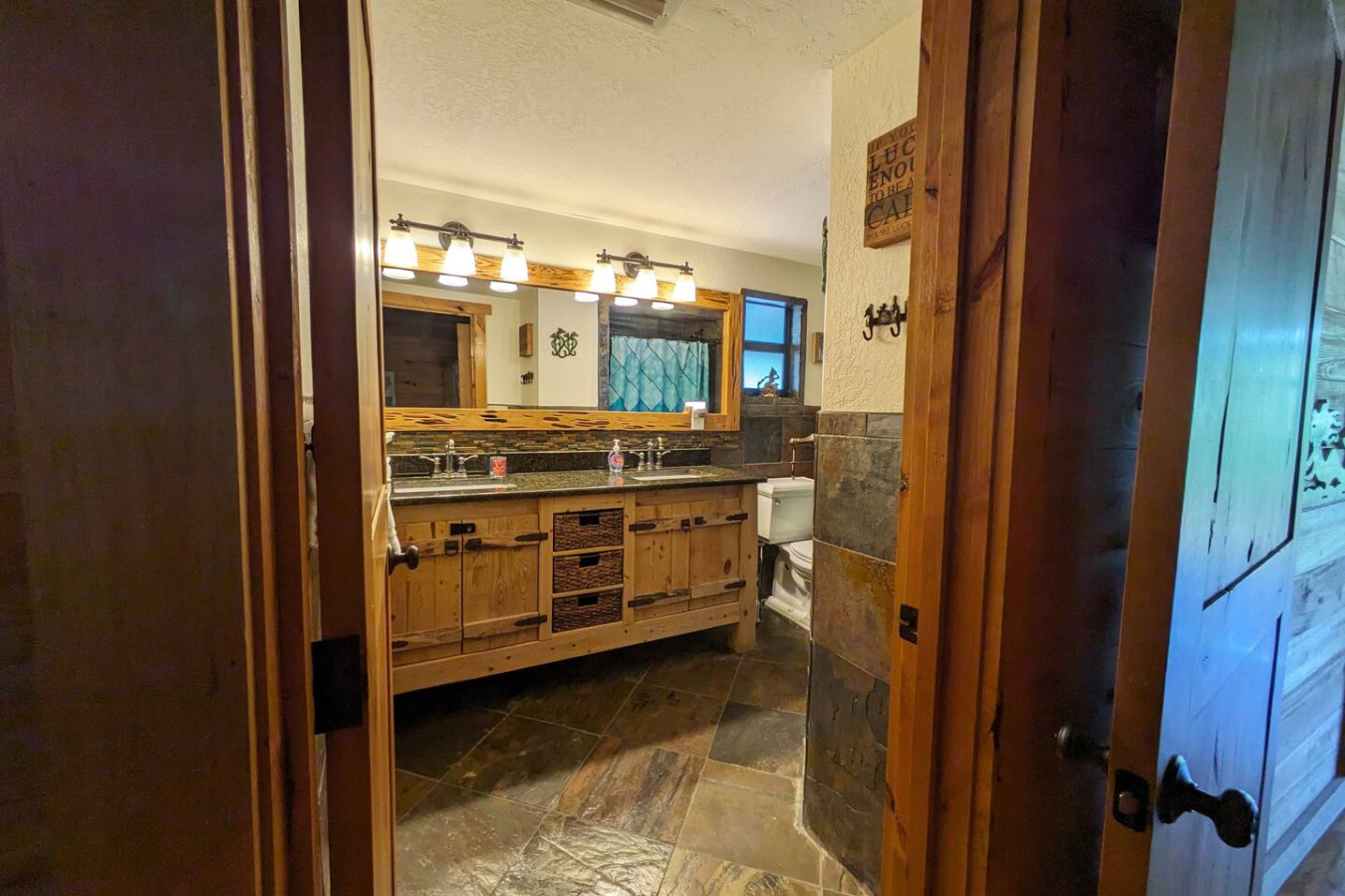 Bathroom with a double vanity and slate tiling