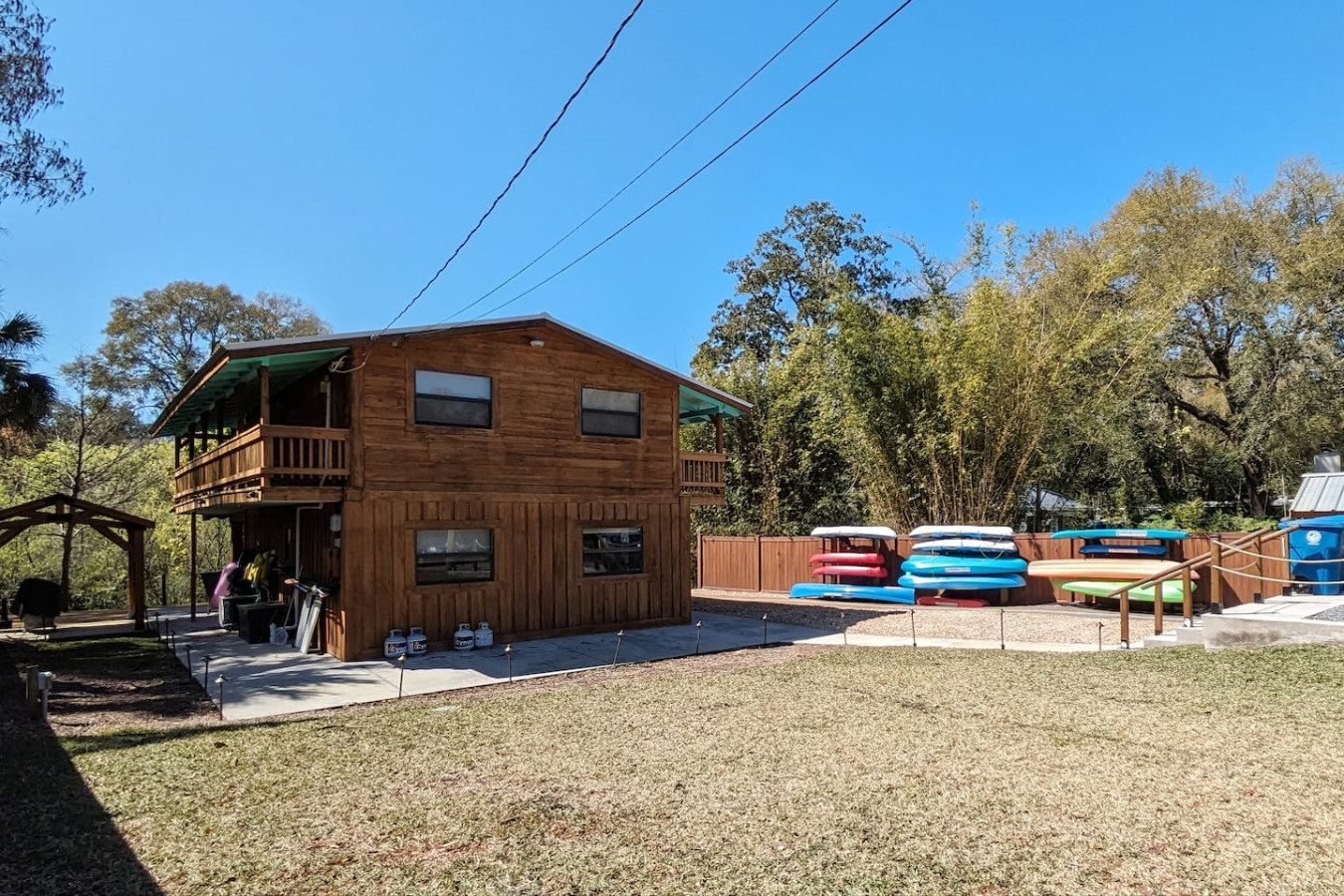 The house from the lawn, with the kayak racks