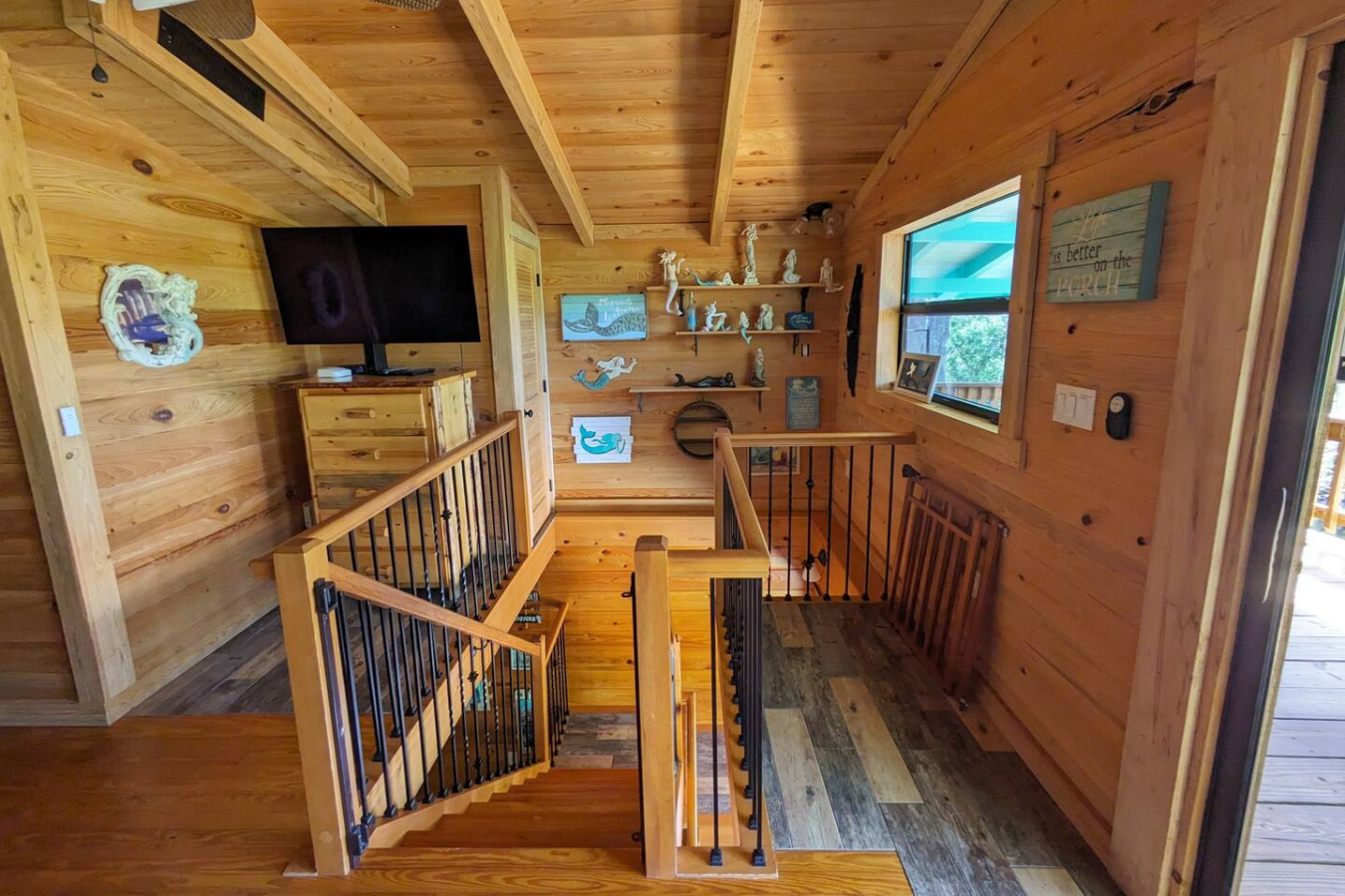 The upstairs landing and its mermaid shelf