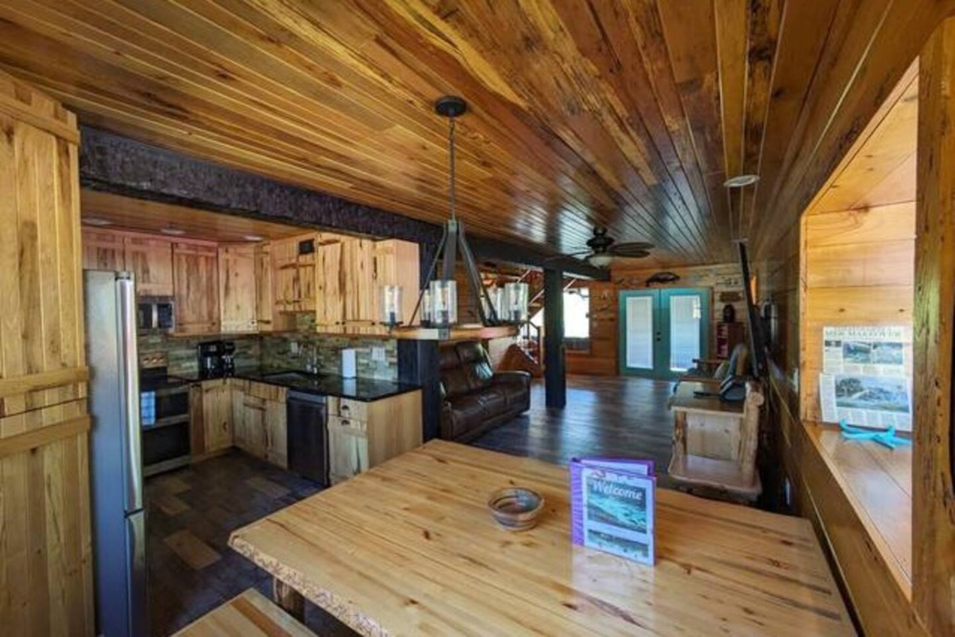 Dining table and kitchen, looking through to the front doors