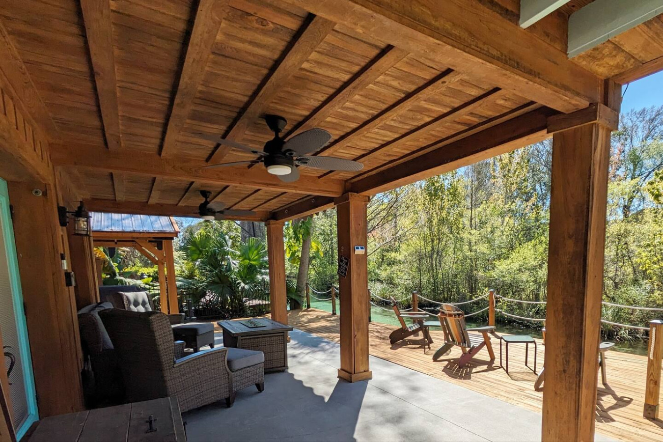 Covered lounge beneath the deck, open to the river