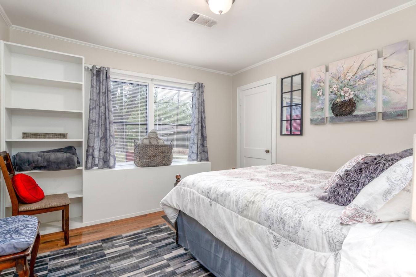 The Garden Room is Bedroom #3. Features a Queen bed, built-in cabinets, and TV.