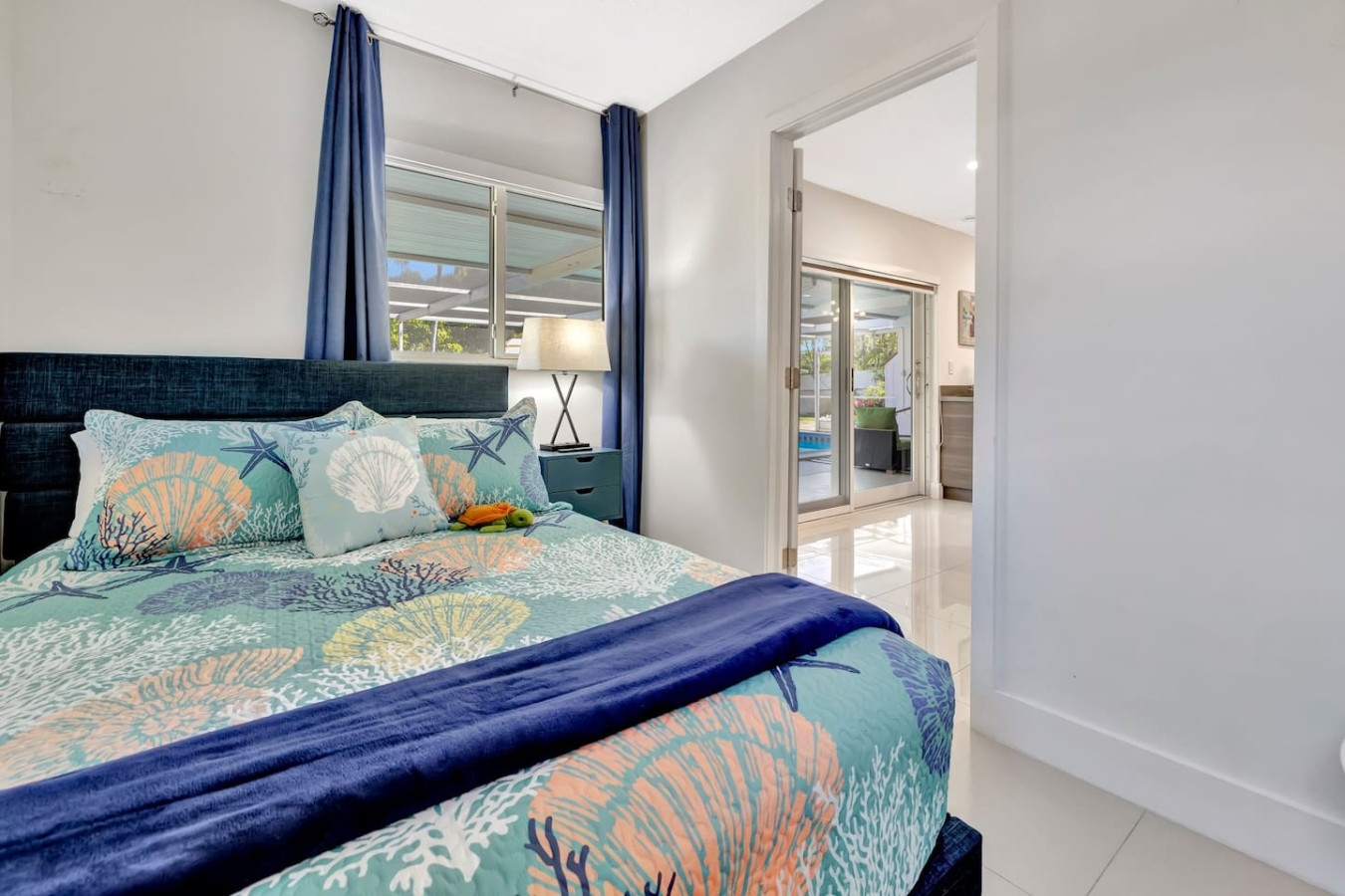 Discover comfort just steps away from the living area in our bedroom, featuring a queen bed and nestled conveniently beside the living room for easy access and a restful night’s sleep.