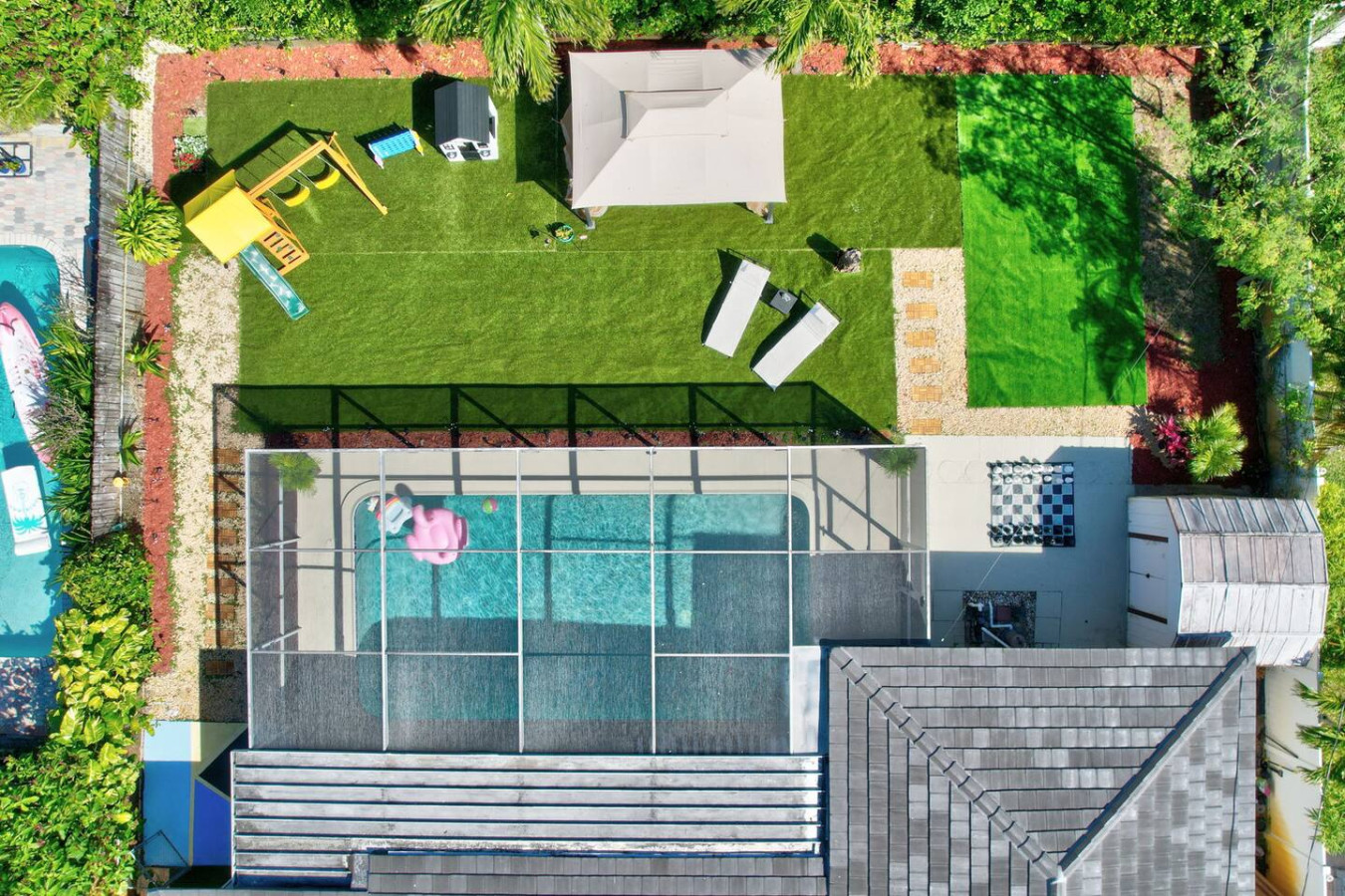 Bird's eye view of the green backyard and pool