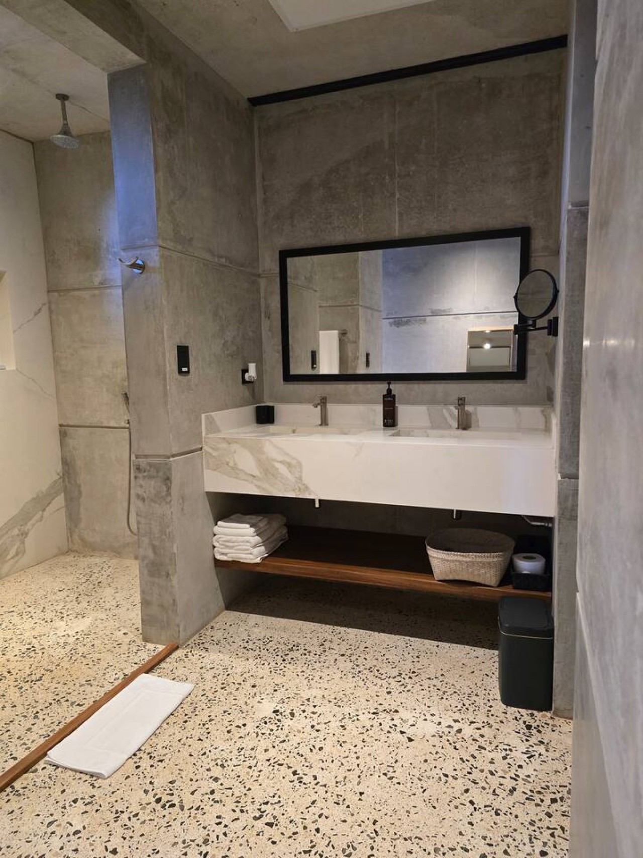 Enjoy sleek design & refreshing comfort! This modern bath features a single mirror & sink, a private, closable toilet, hot shower, & hair dryer. Complimentary curated shampoo, gel, rinse await. Our team can suggest spas or stores for beauty products!