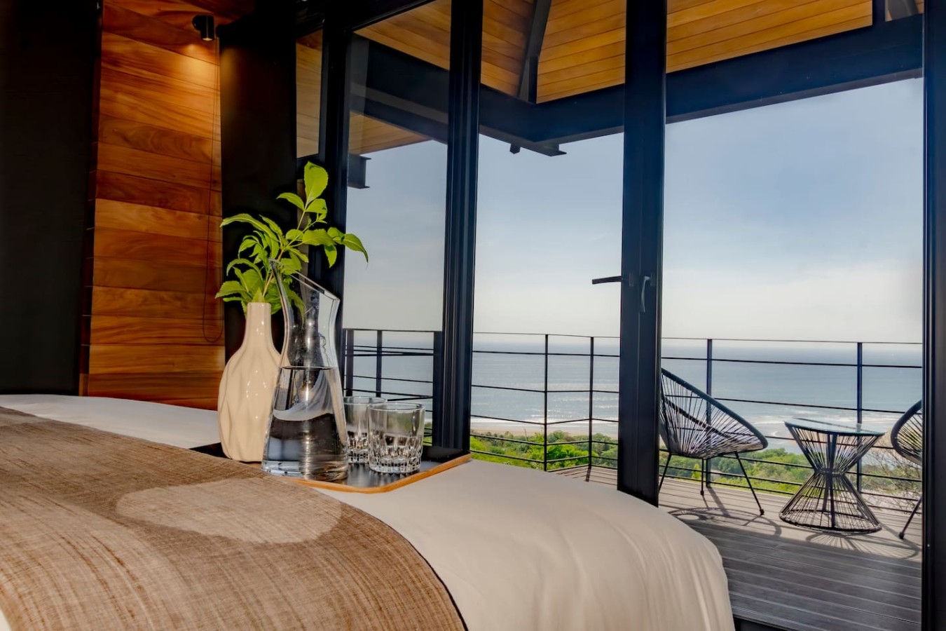 Flexible comfort awaits! This room features a king bed that converts to two singles, A/C & blackout curtains for restful sleep. And small desk perfect for work. Your balcony connects directly to the pool. Contact us for any bed arrangement questions!