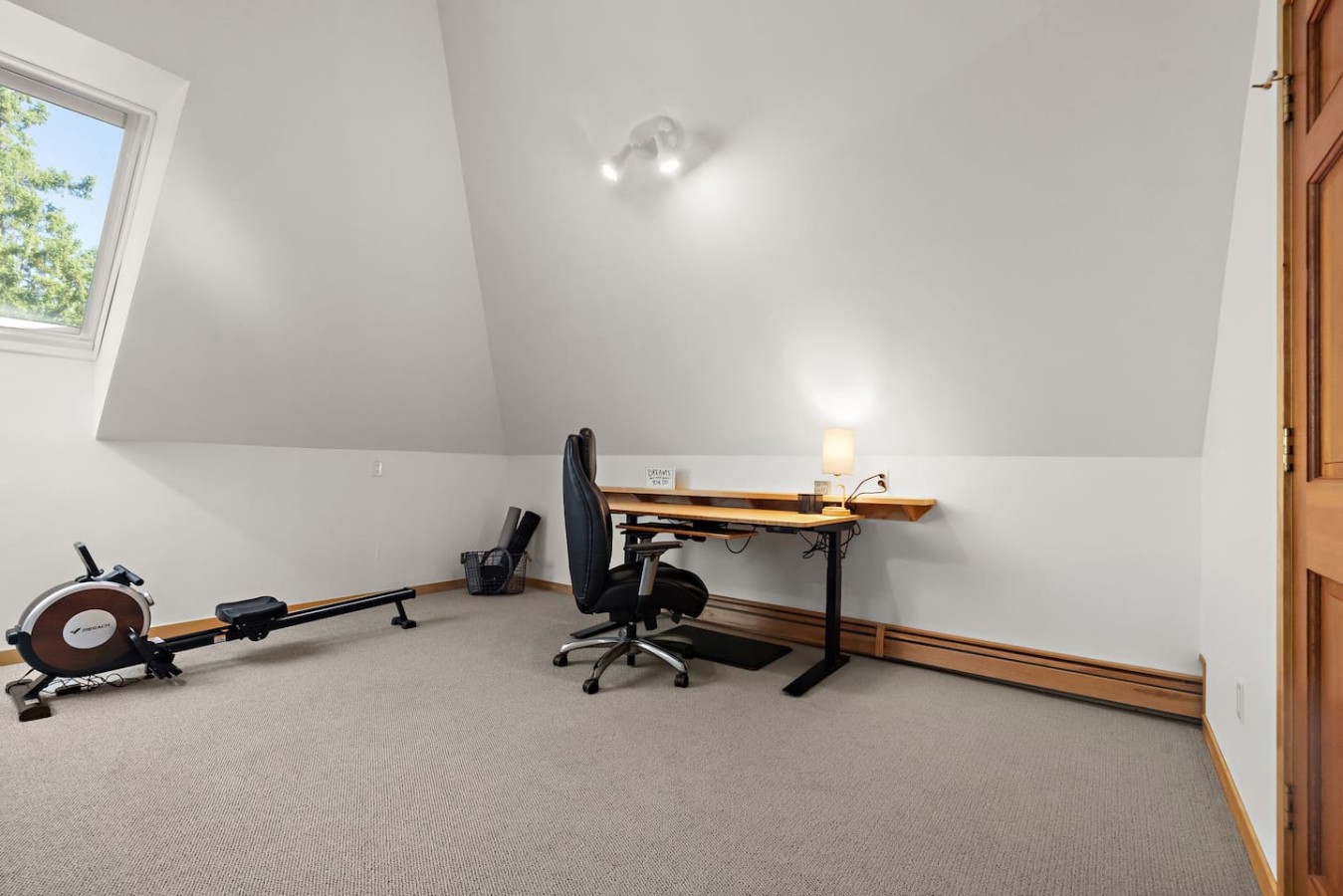 Remote work space with standing desk and gym equipment