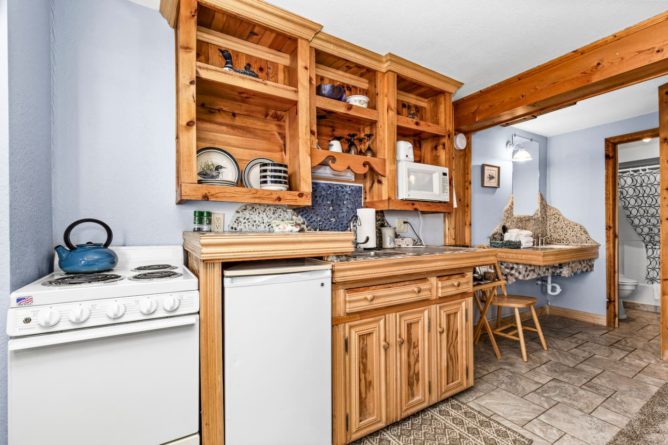 Kitchenette with efficiency range/oven, mini fridge, microwave, and coffee maker