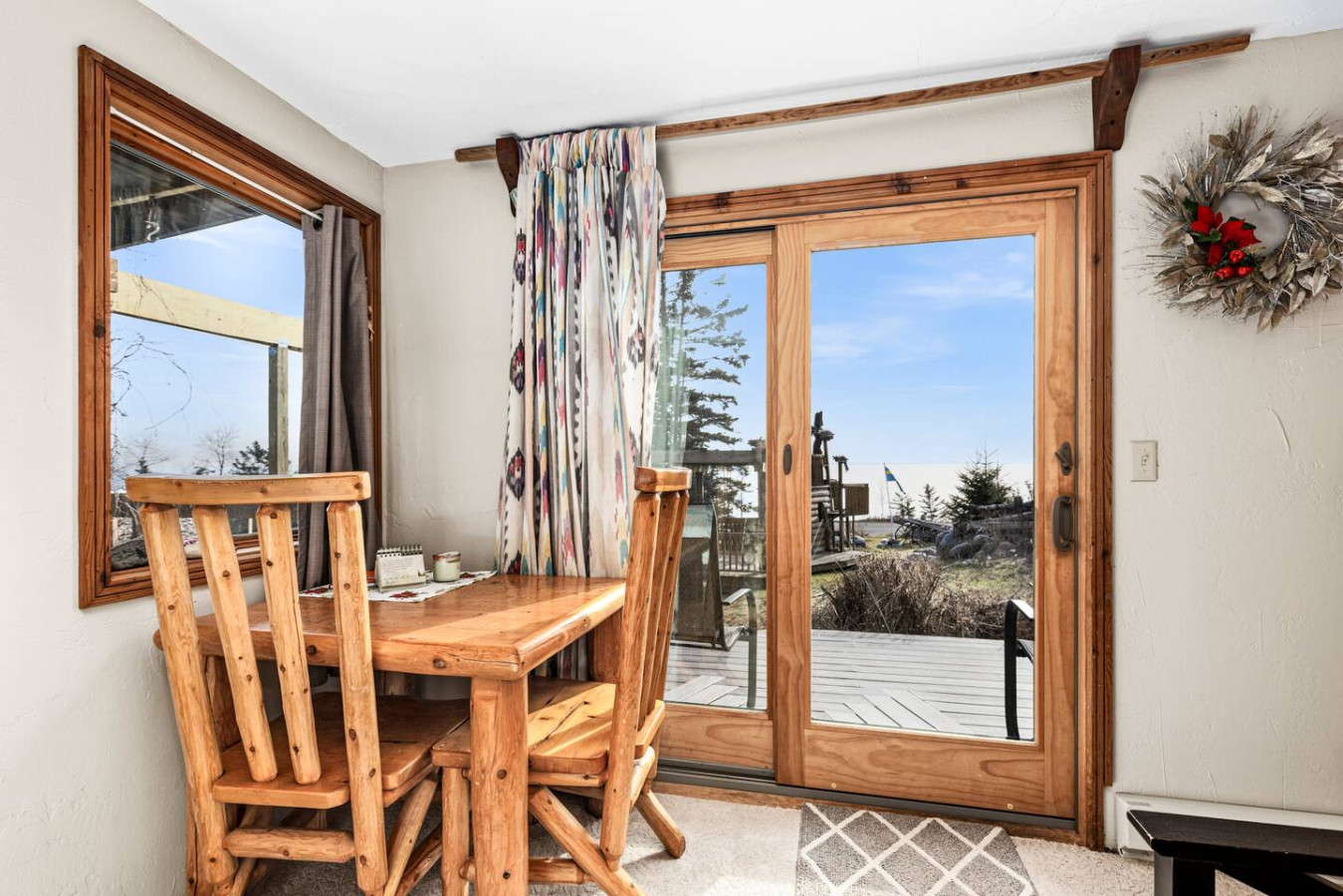 Wood table with views of Lake Superior through large sliding glass door.