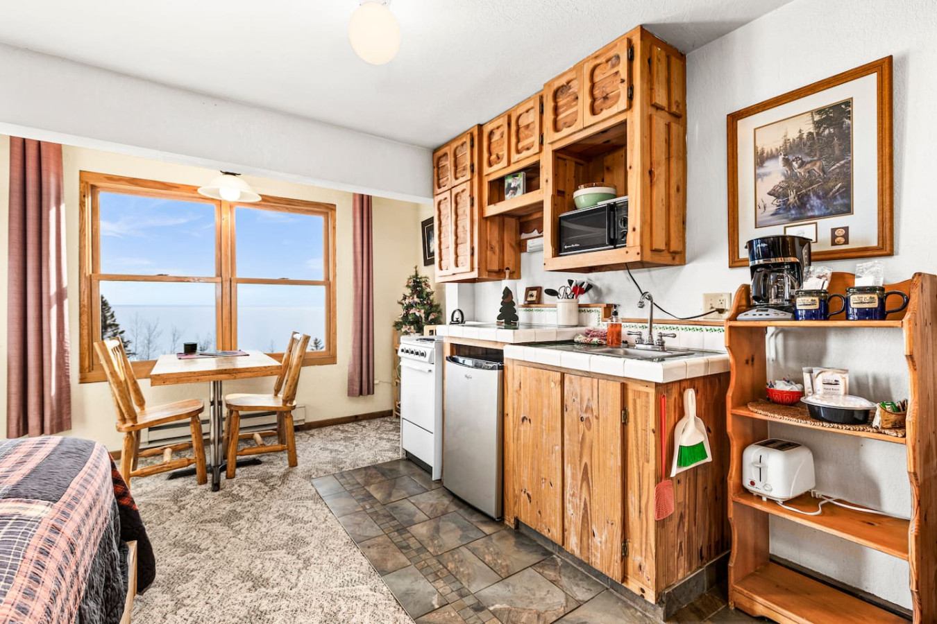 Kitchenette with efficiency range/oven, mini fridge, microwave, and coffeemaker