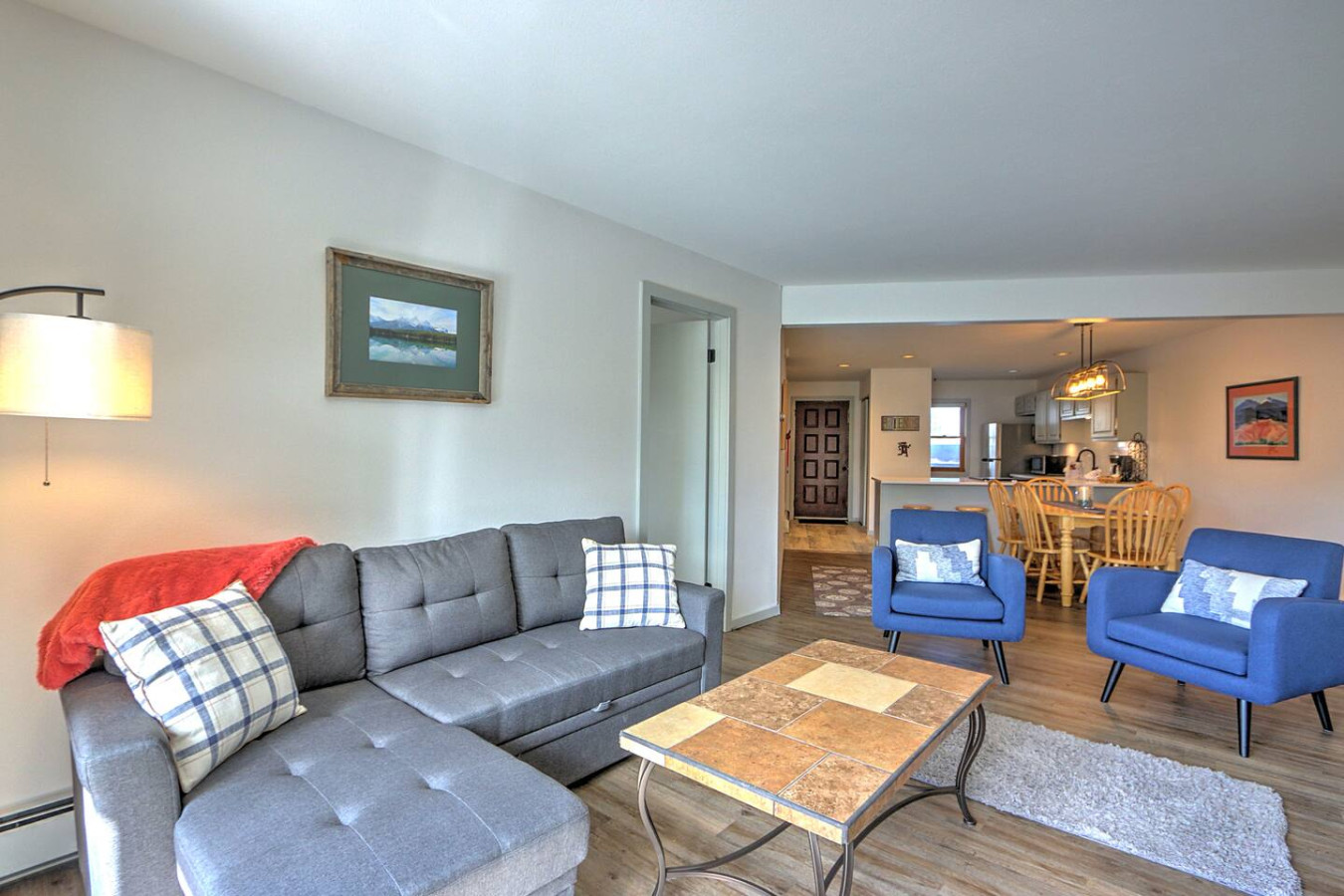 Living room with fold-out couch and  view into dining area and kitchen