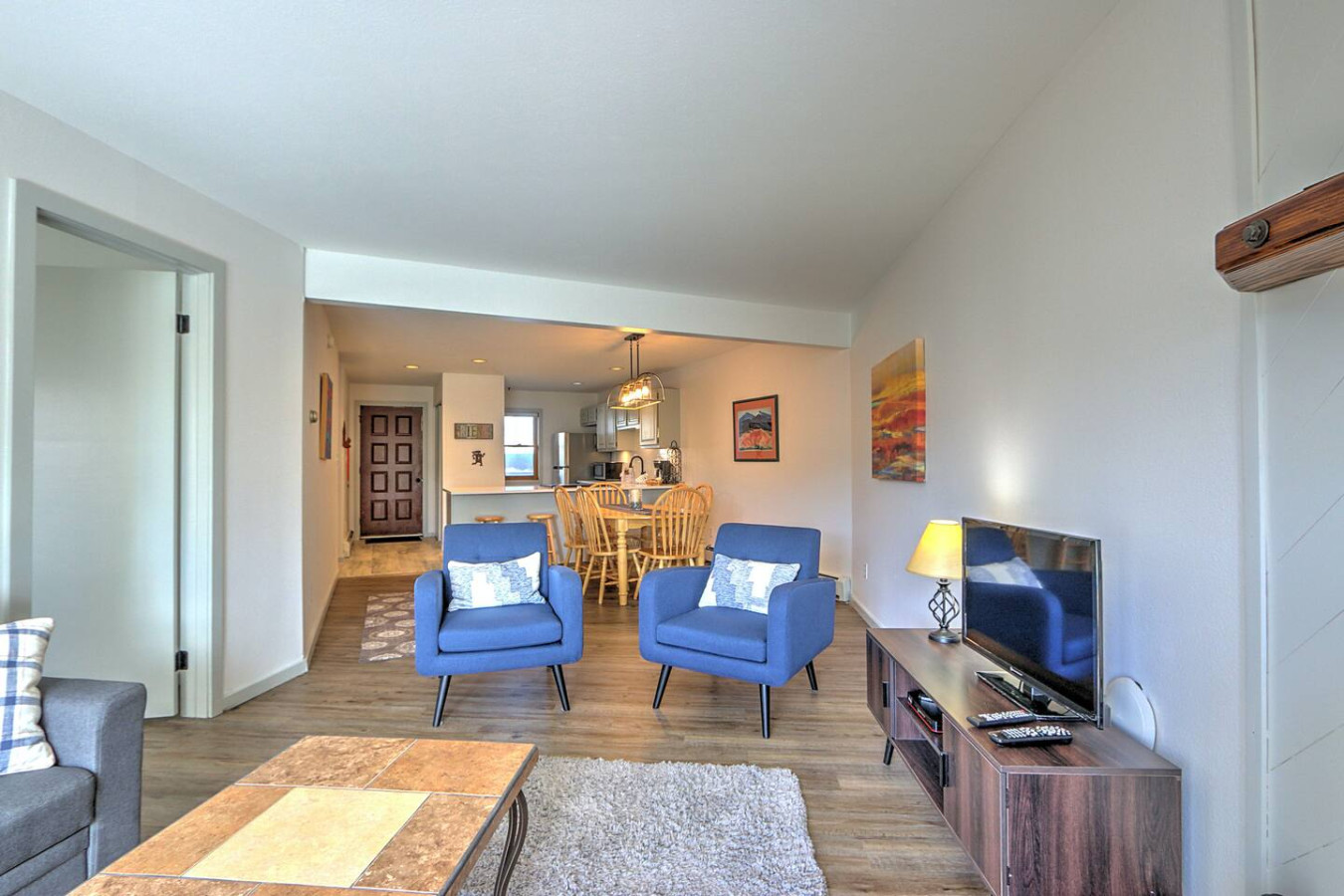 Living room with view into dining area and kitchen