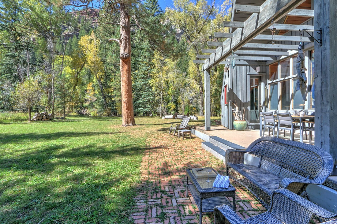 Back patio dining area and additional seating steps from river