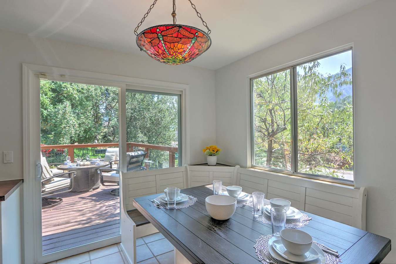 Dining area with deck access and mountain views