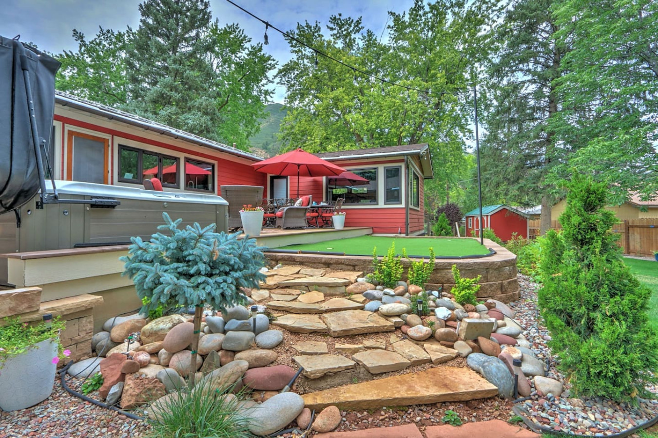 Back patio with putting green, hot tub and outdoor seating