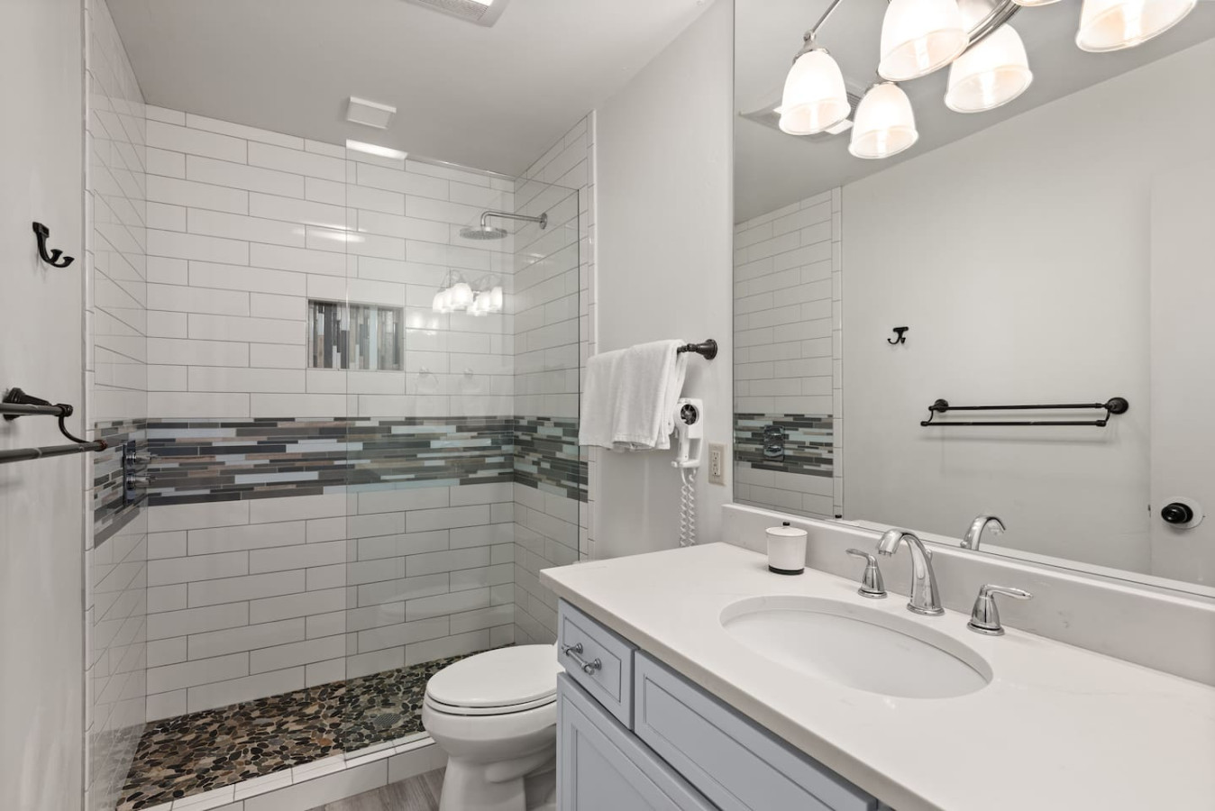 Upper level bedroom with glass enclosed shower