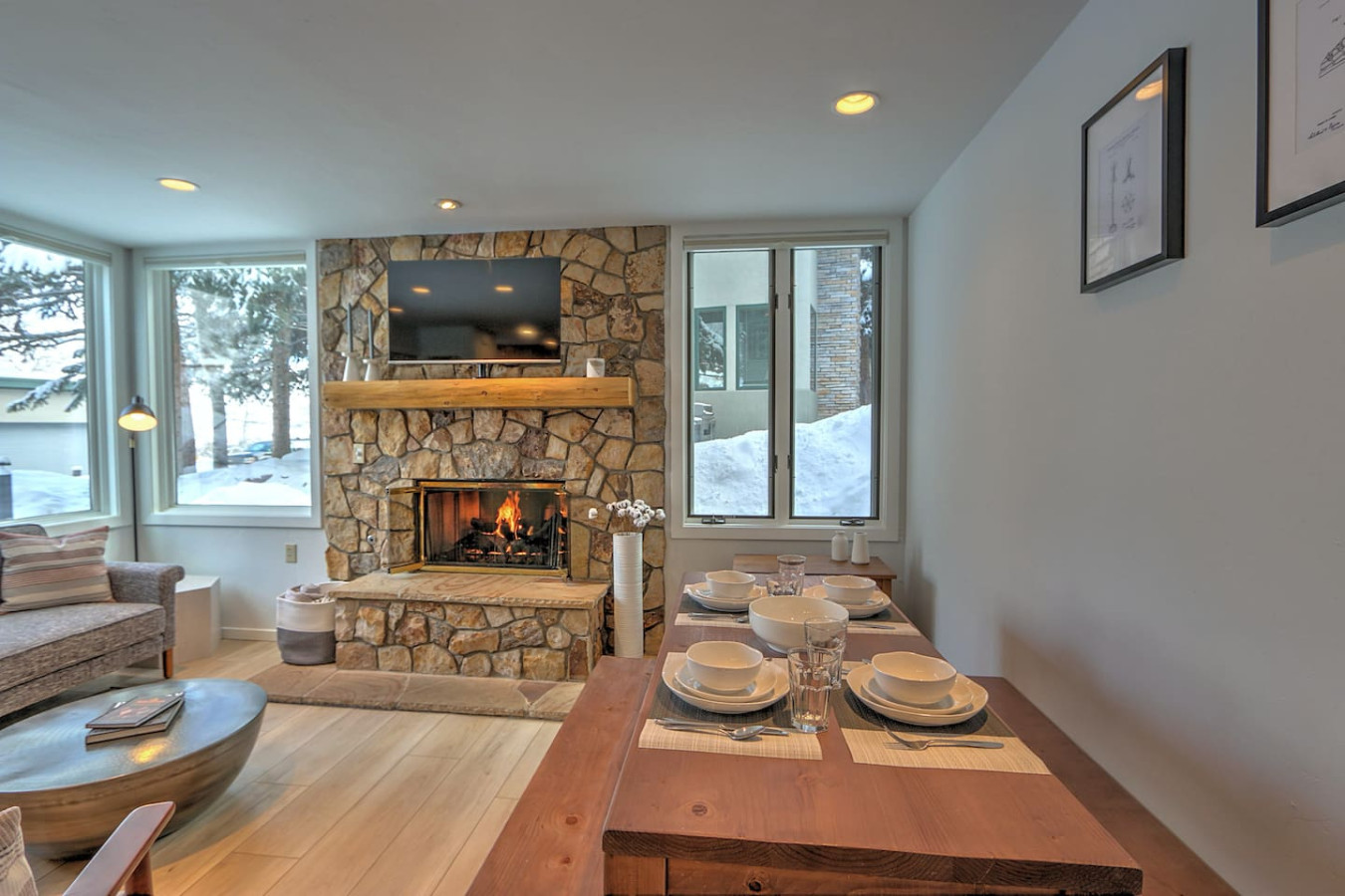 Comfortable, stylish living room with gas fireplace and dining table