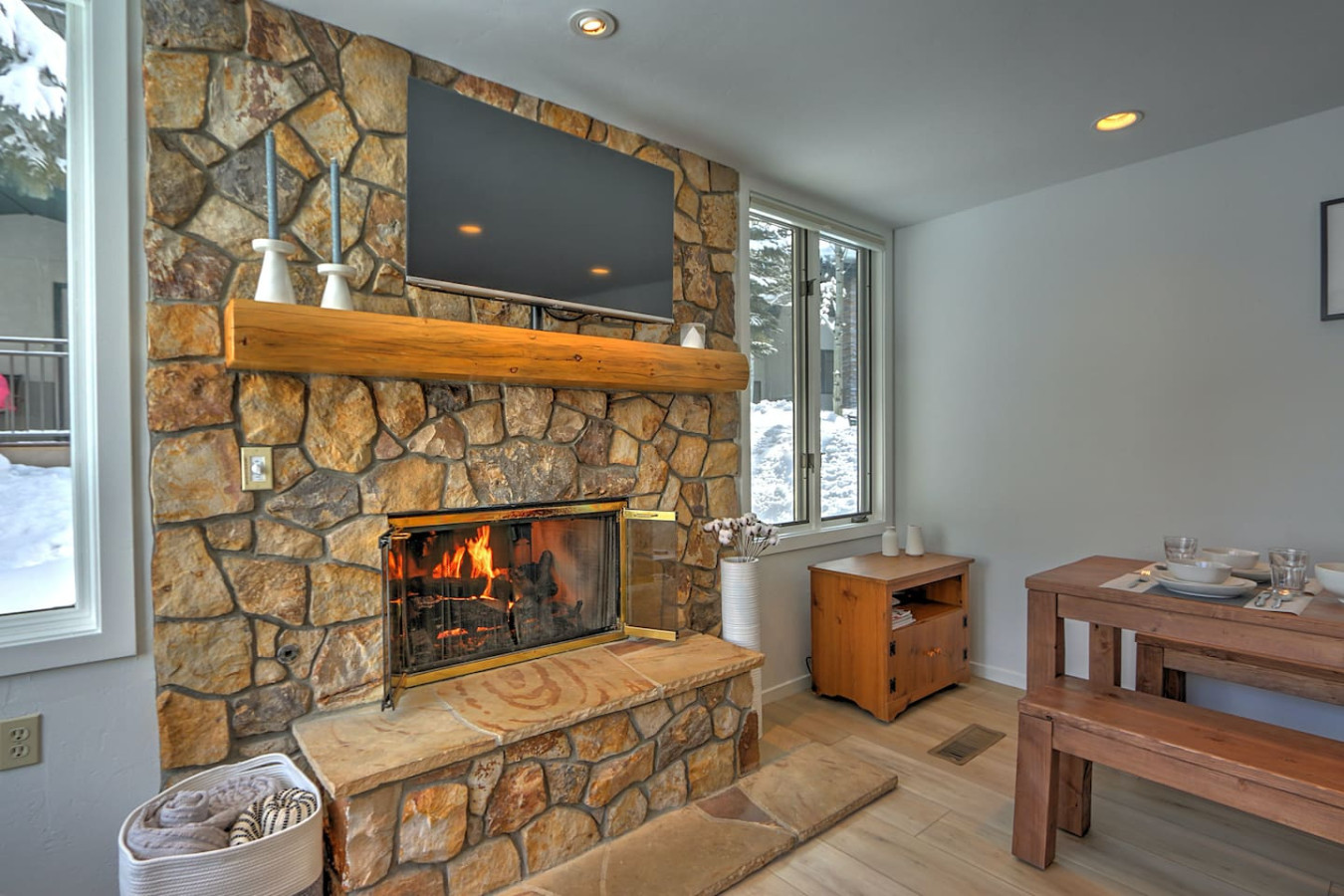 Comfortable, stylish living room with gas fireplace and dining table