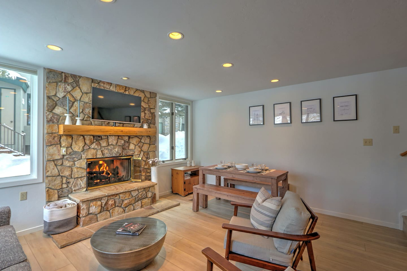 Comfortable, stylish living room with gas fireplace and dining table