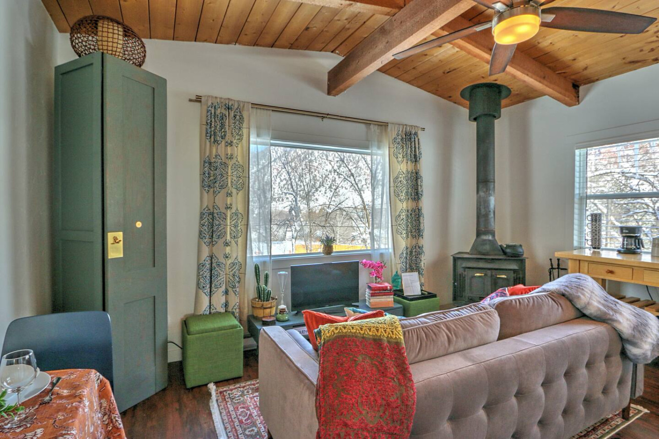 Living area with comfortable furnishings, wood burning stove and mountain views