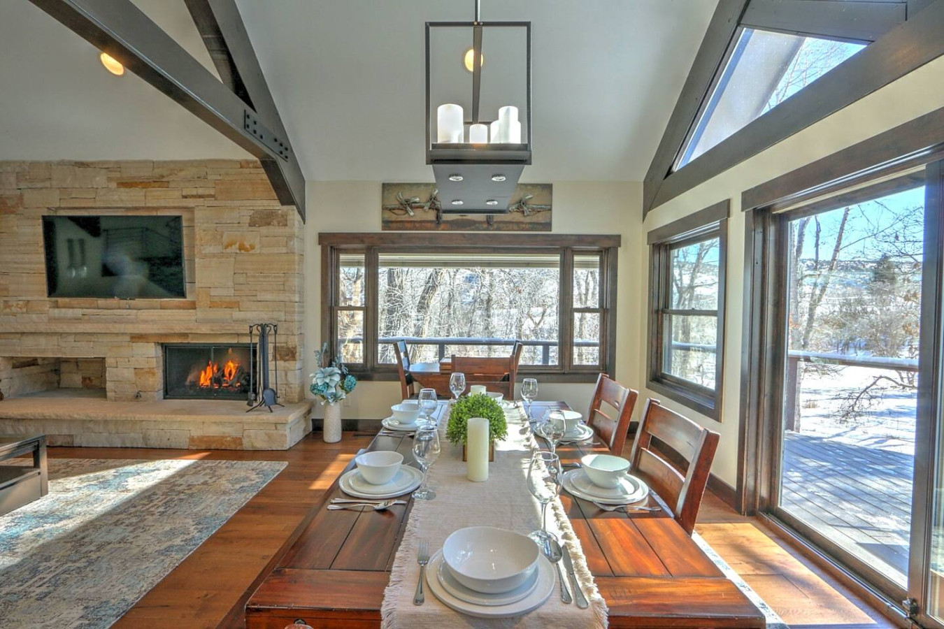 Open living and dining area with expansive windows & patio access