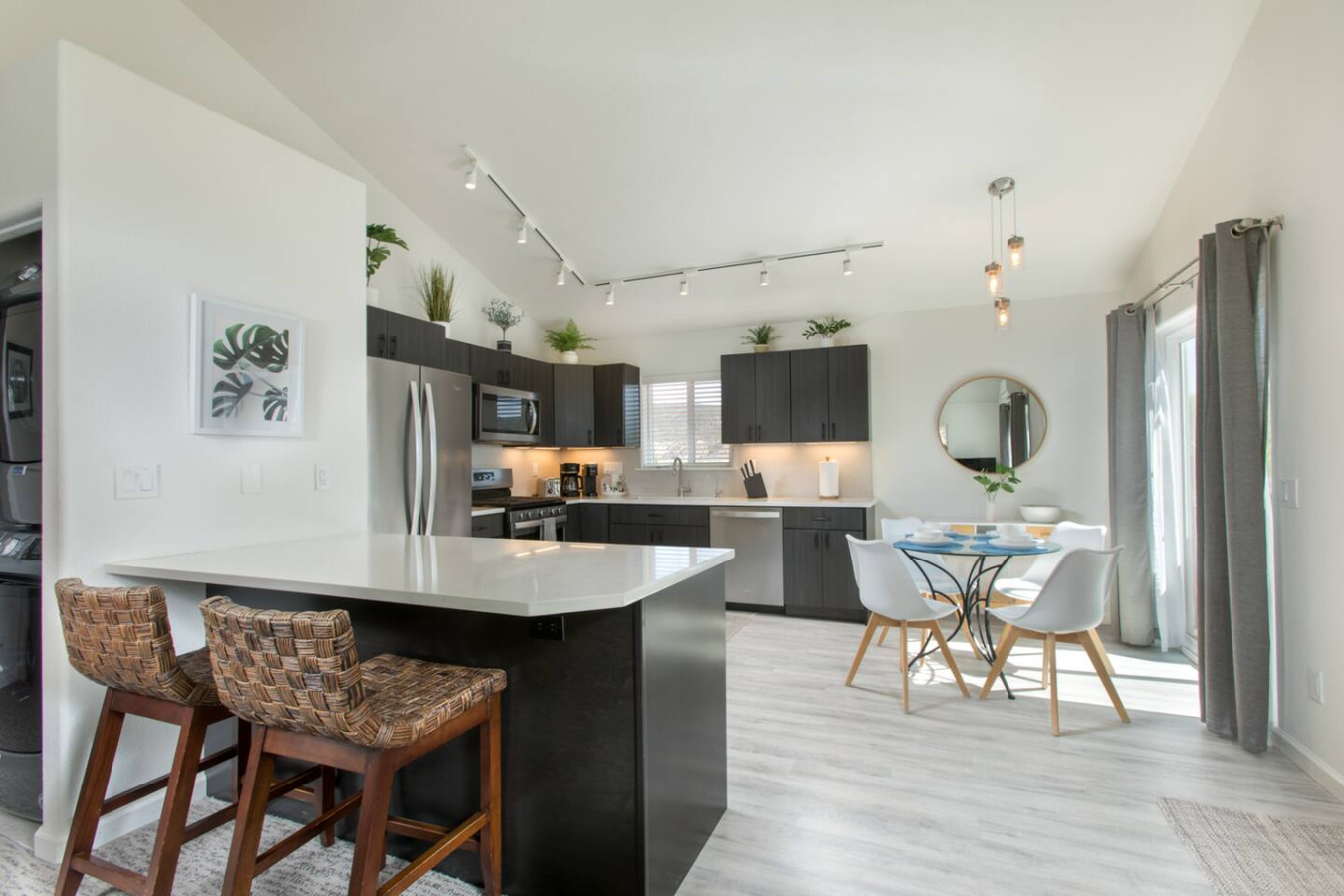 Open, modern kitchen with bar seating and table for four