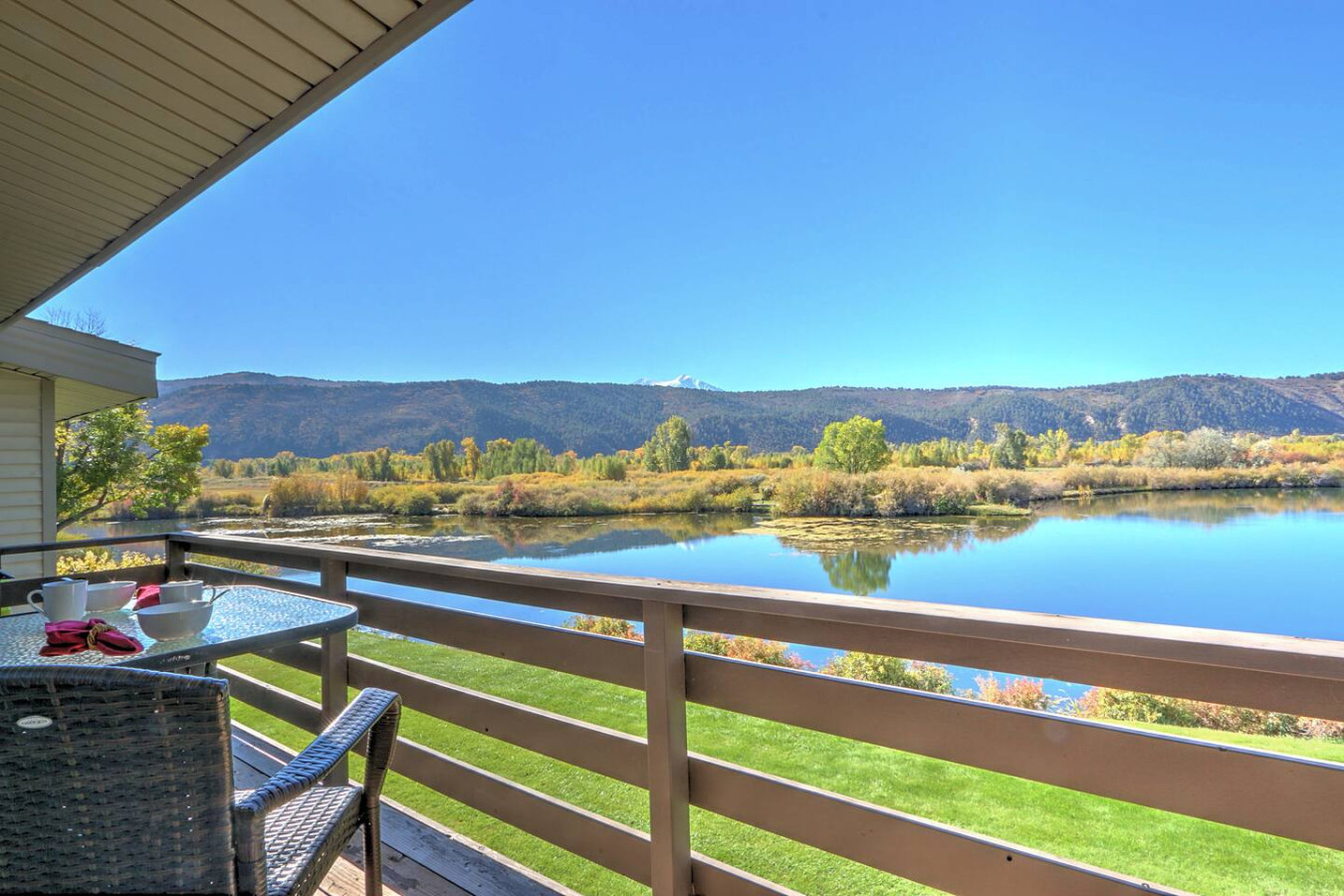 Primary bedroom balcony access with pond views